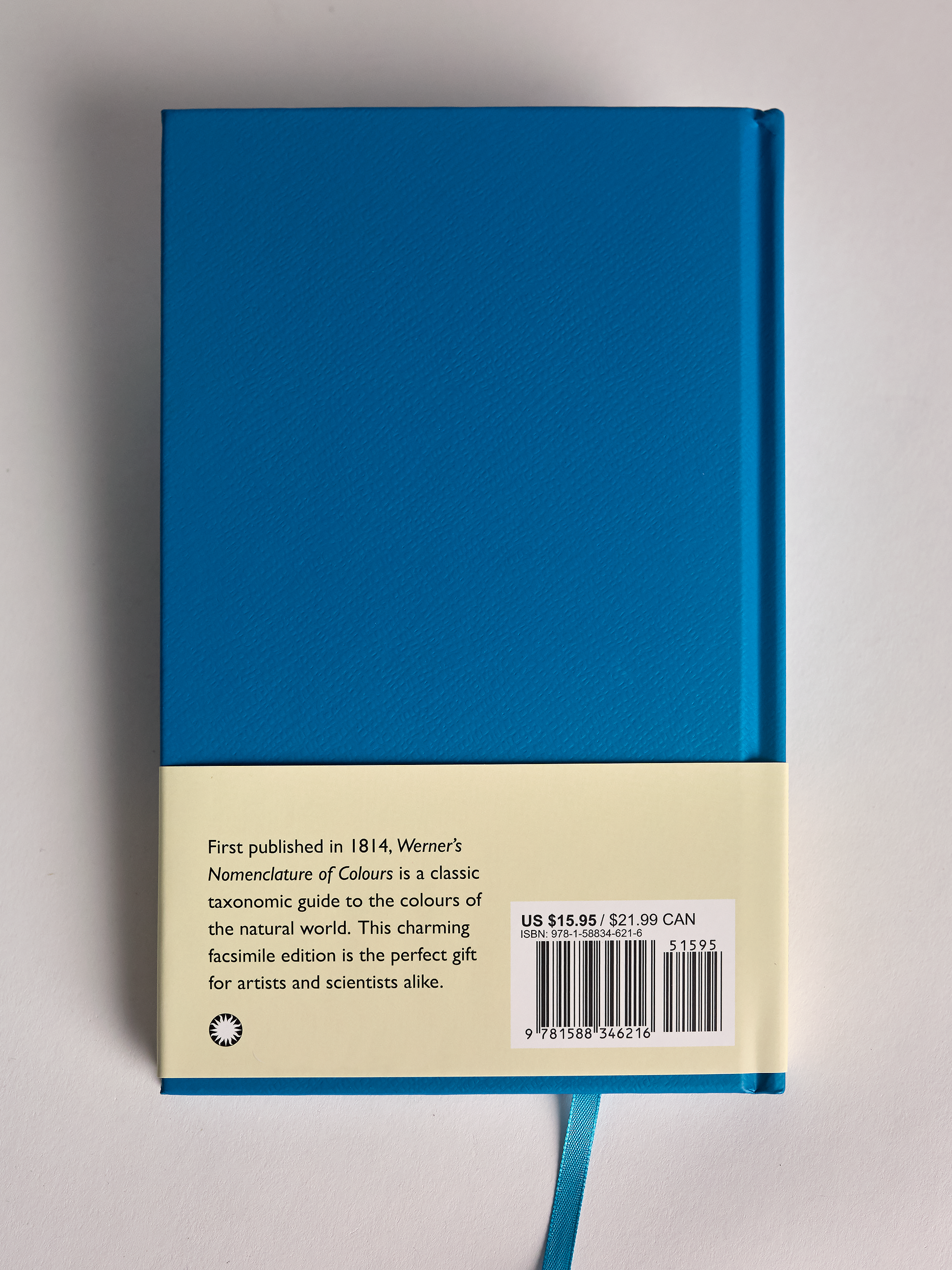 Blue book titled 'Werner's Nomenclature of Colours' back cover on a gray background