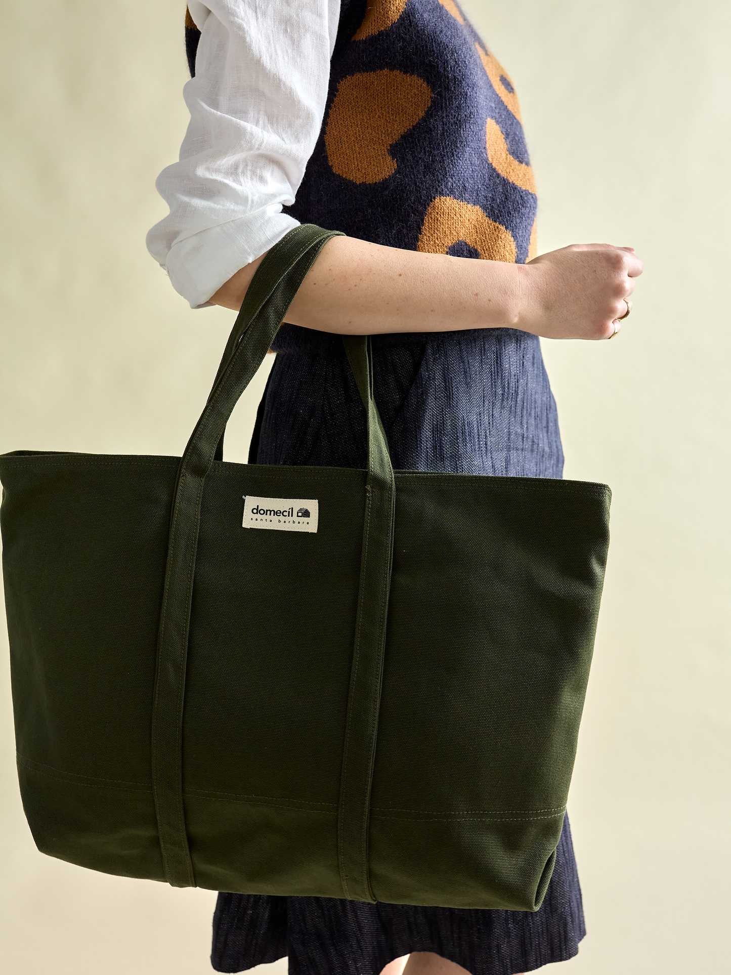 Domecíl Forest Canvas Tote hanging on arm of model