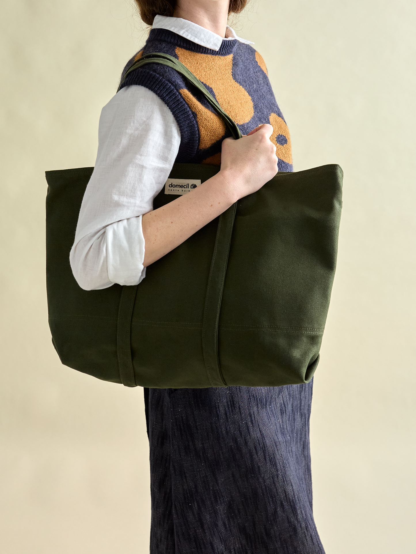 Domecíl Forest Canvas Tote side profile on model hanging on the shoulder