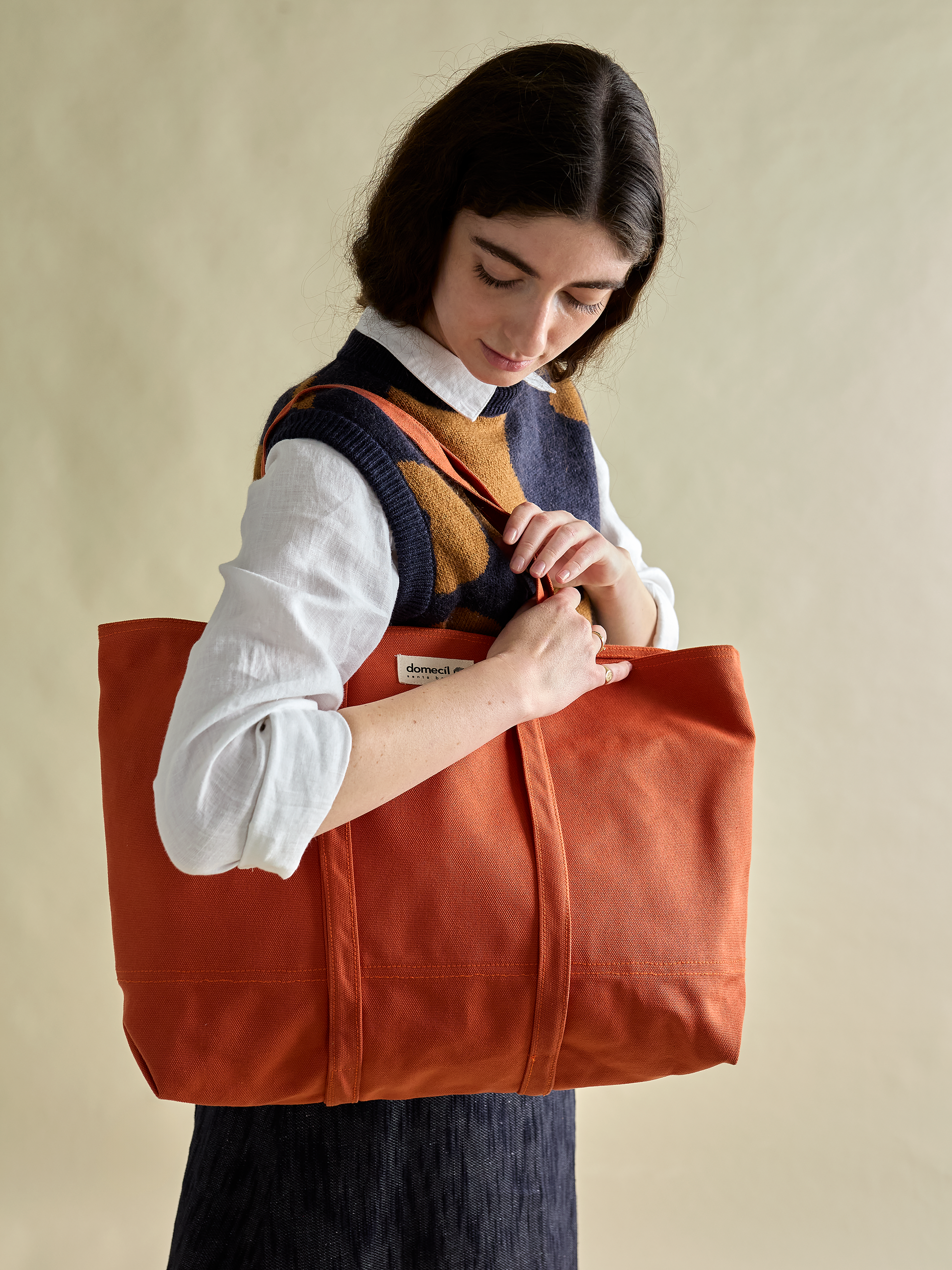 Model looking down at domecíl Orange Canvas Tote