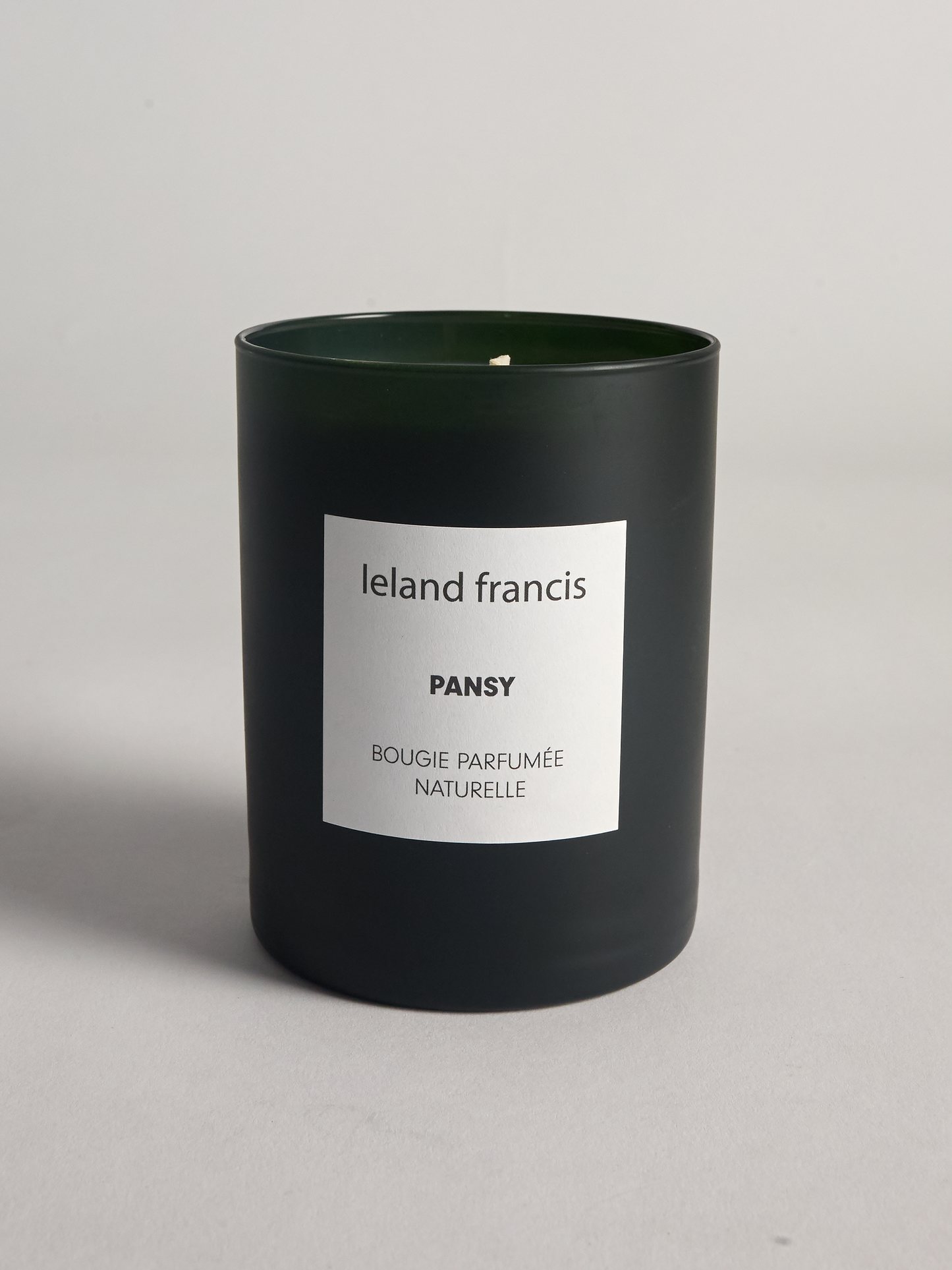 Pansy candle from Leland Francis with a white label on a gray background