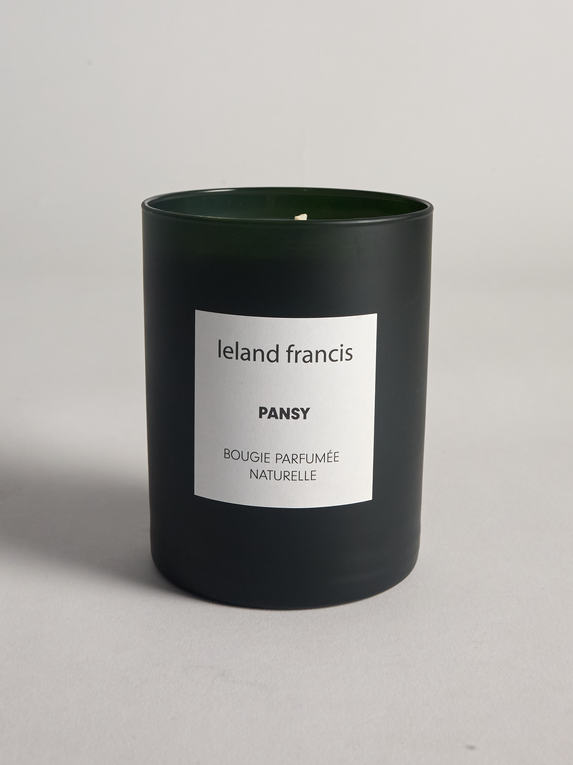 Pansy candle from Leland Francis with a white label on a gray background