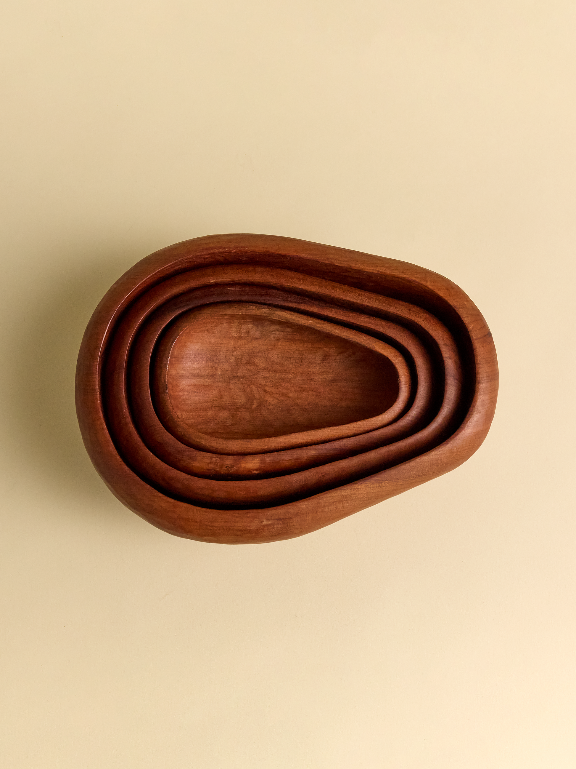 Hand Carved Rauli Nesting Bowls resting together on light background