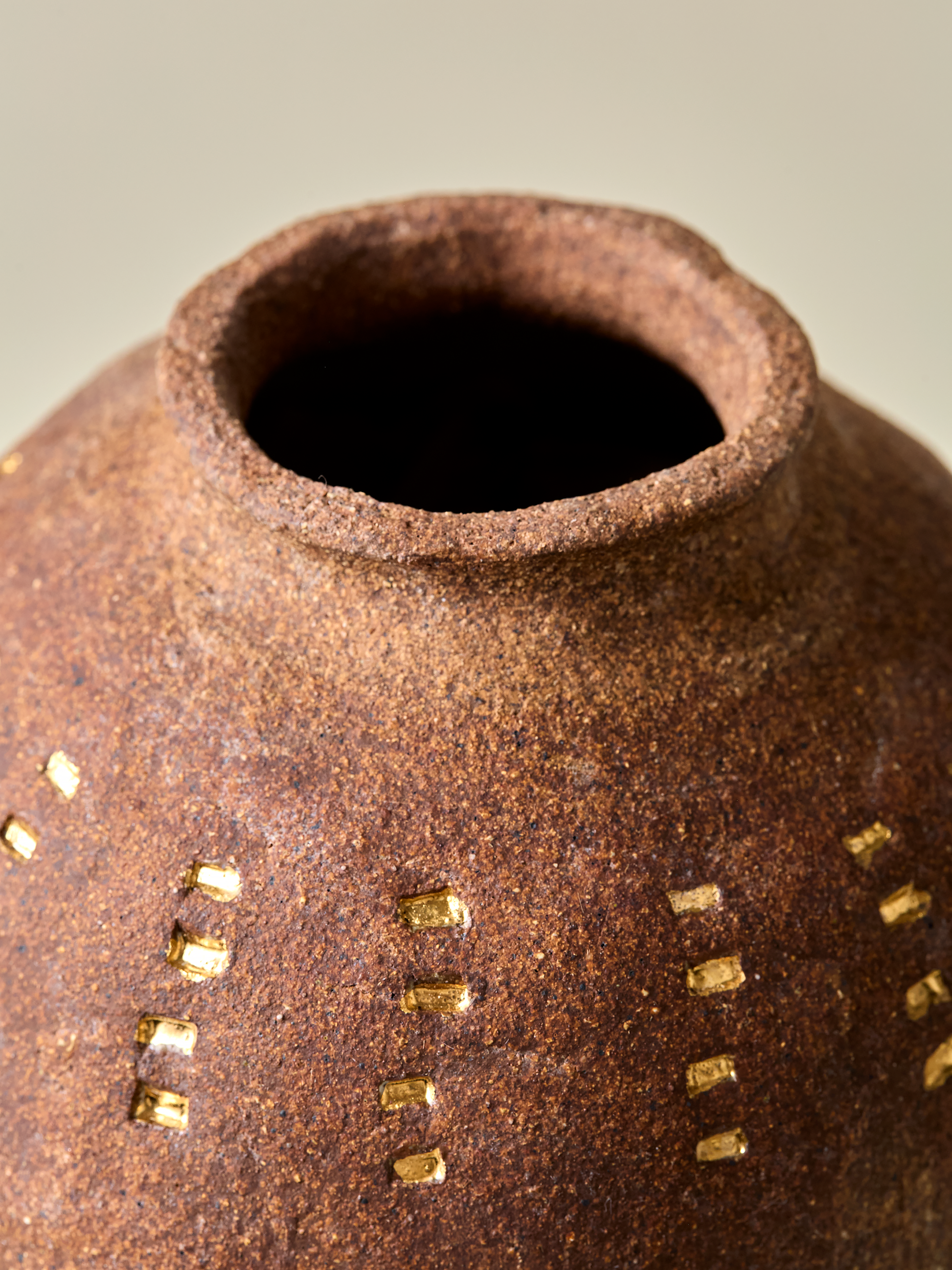 A look inside Pascale Vaquette's burnt sienna vase with gold markings