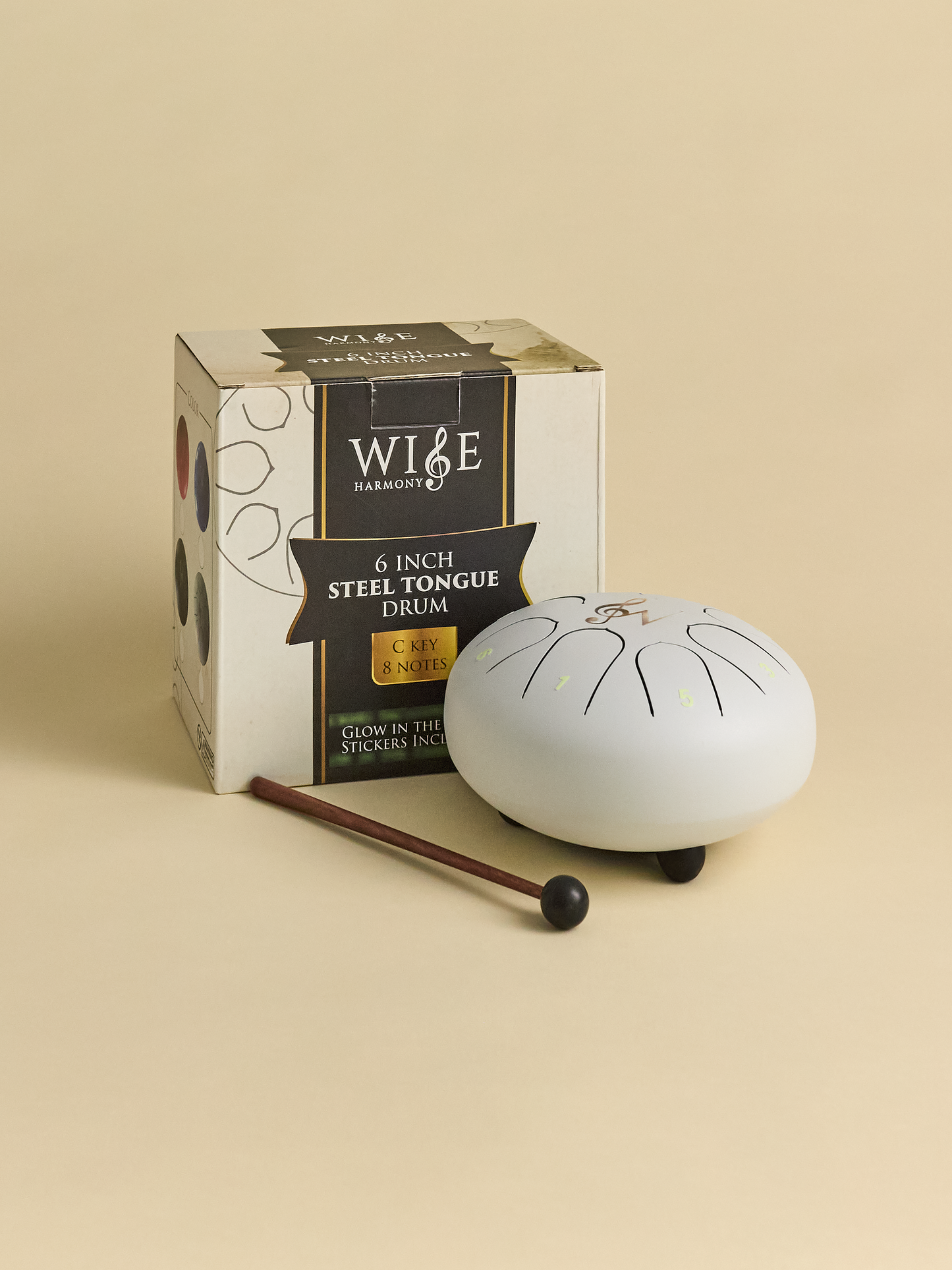 White Steel Drum with box and drumstick on light background