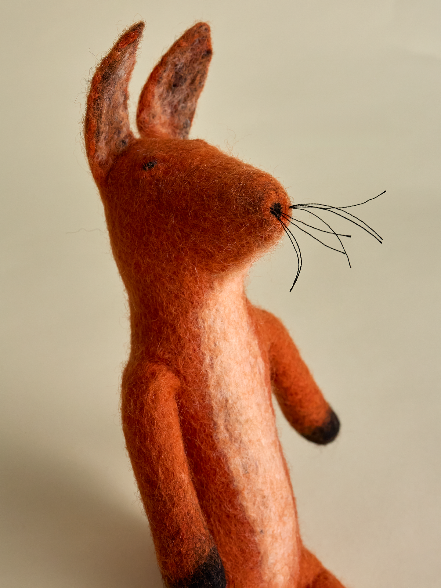 Side view of felt fox with whiskers and upright ears