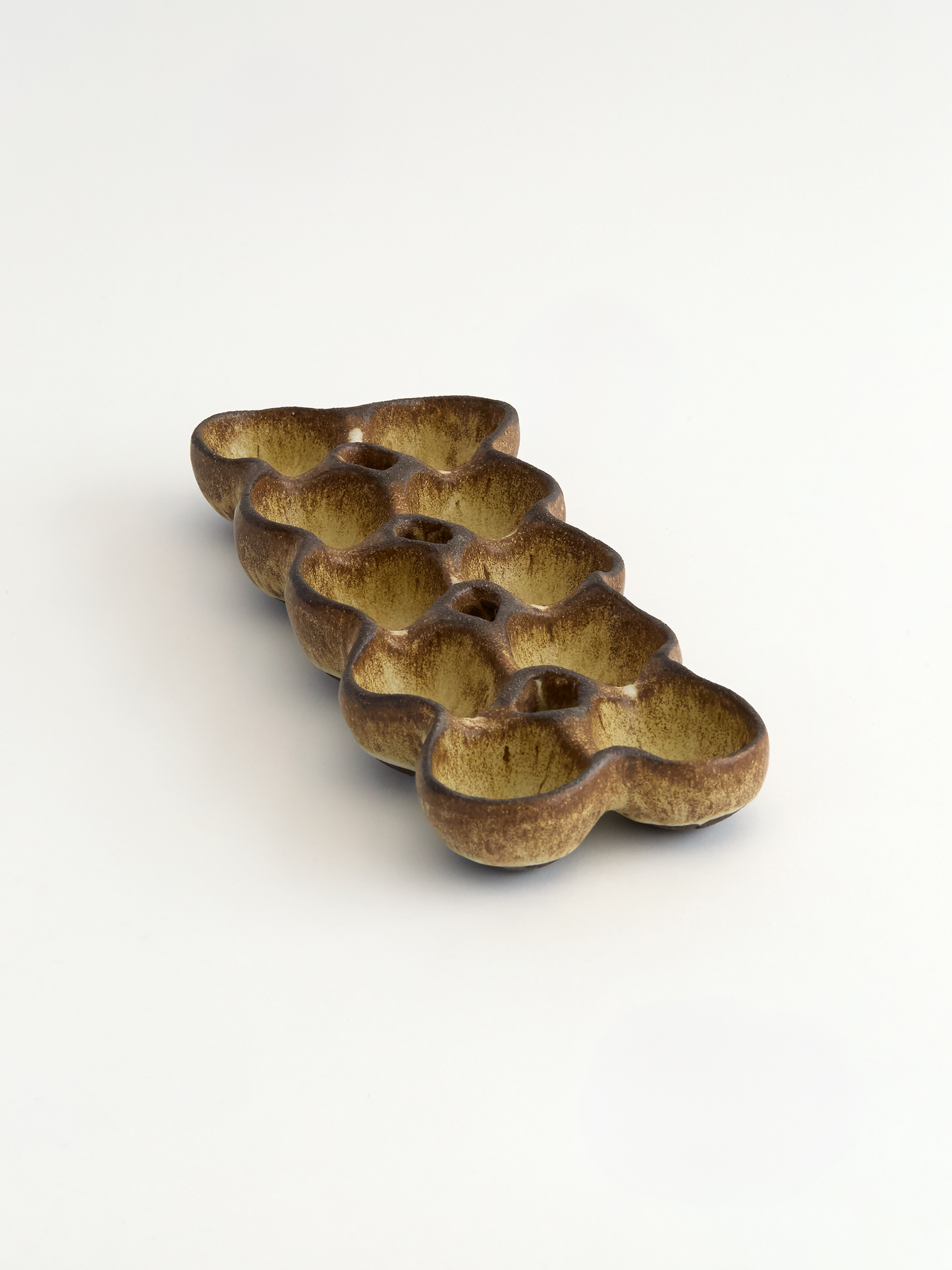 Ceramic egg holder on a white background