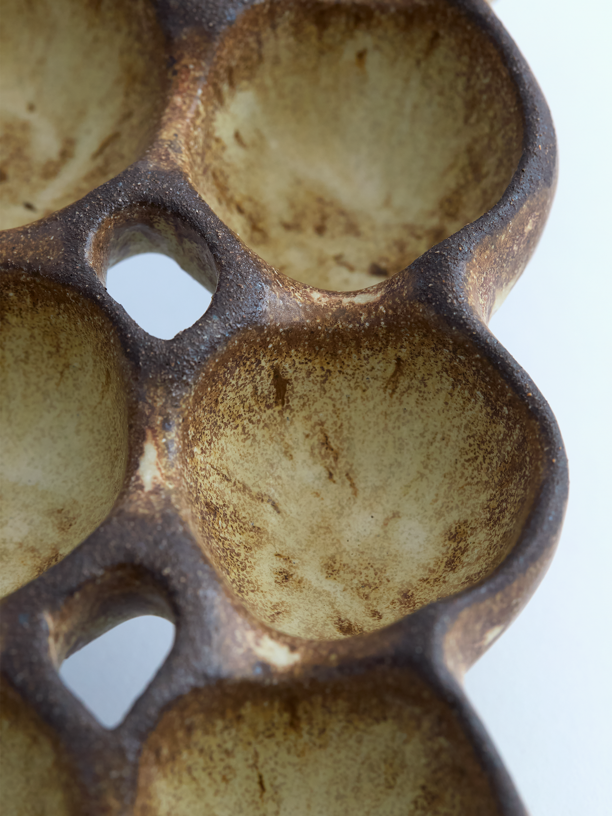 Close-up of a ceramic egg carton with multiple compartments.