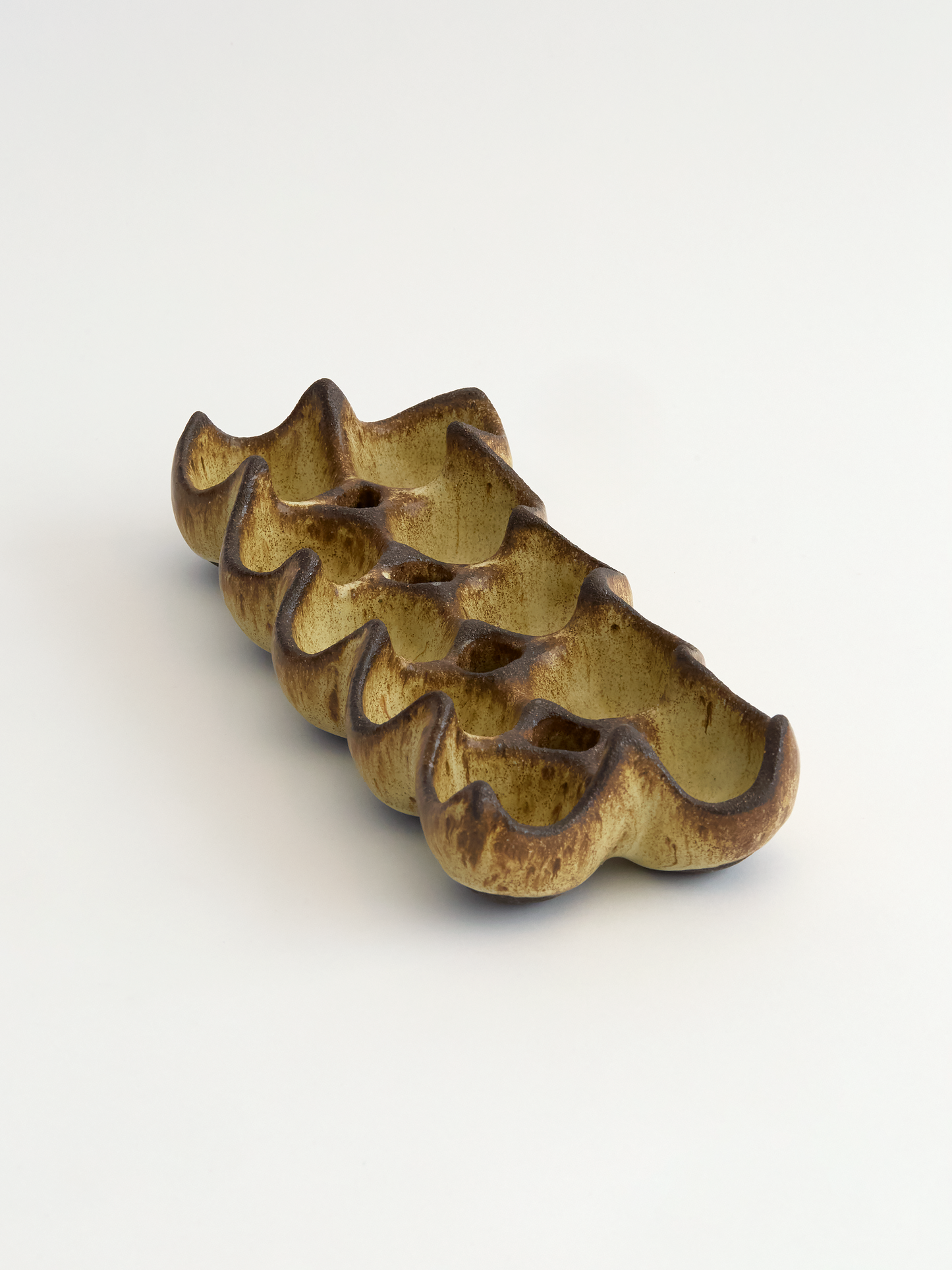Olive brown ceramic ten egg egg holder object on a white background