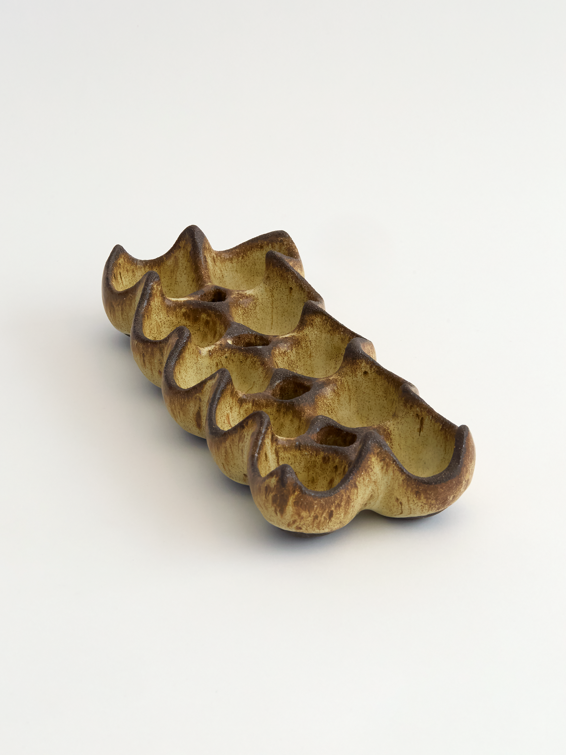Olive brown ceramic ten egg egg holder object on a white background