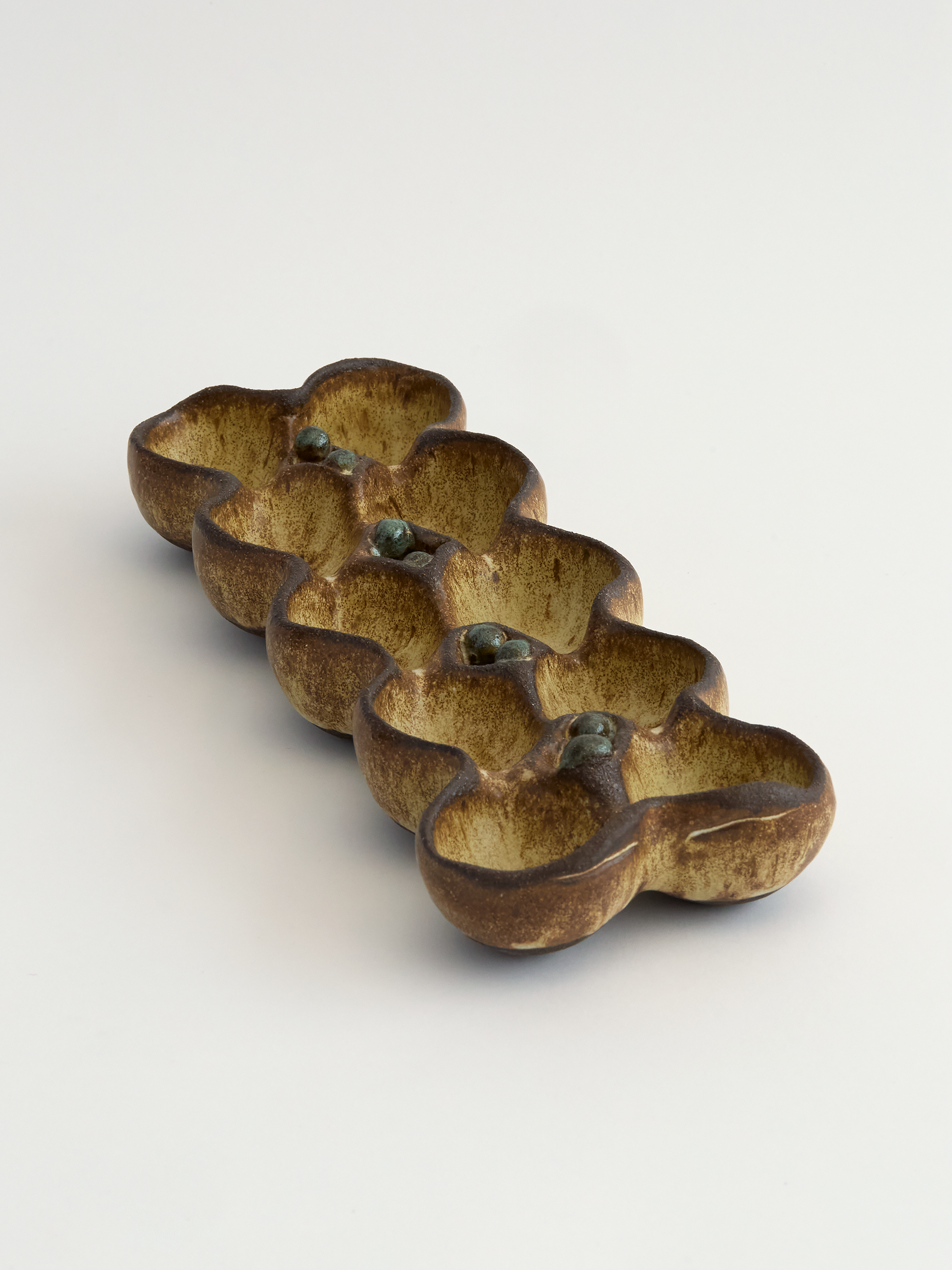 Olive brown rounded edges ceramic egg holder object on a white background