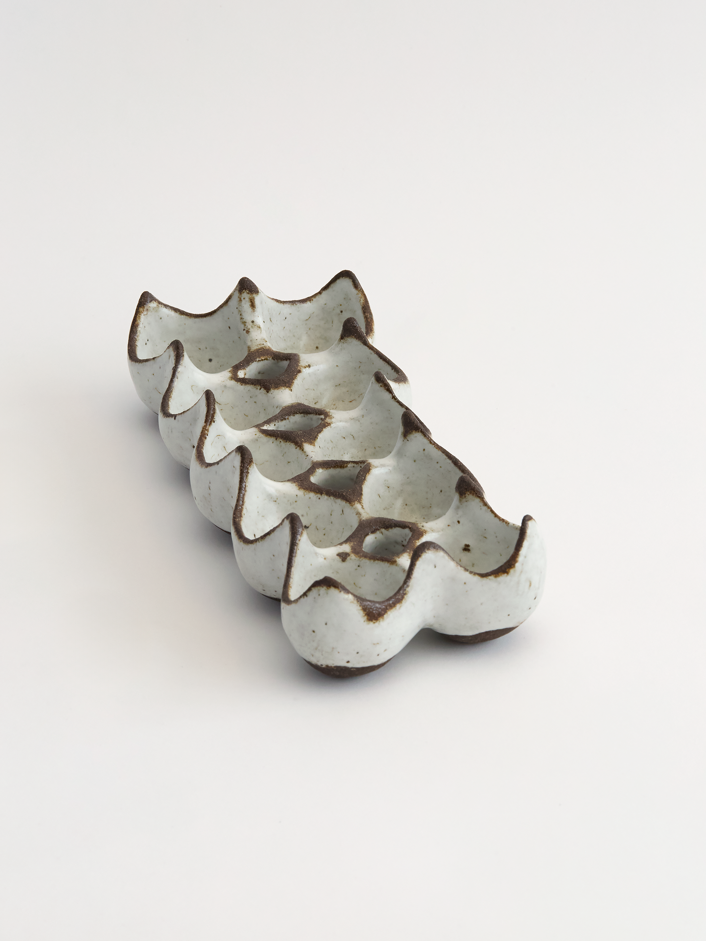 White with brown  edges ceramic ten egg egg holder object on a white background