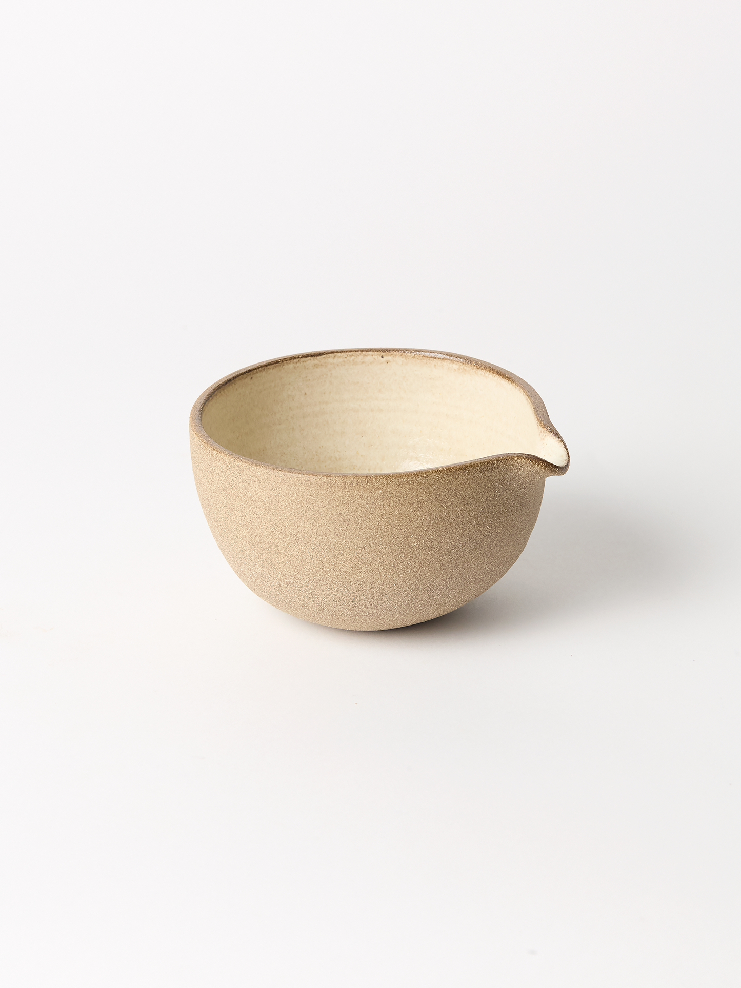 Beige ceramic bowl on a white background