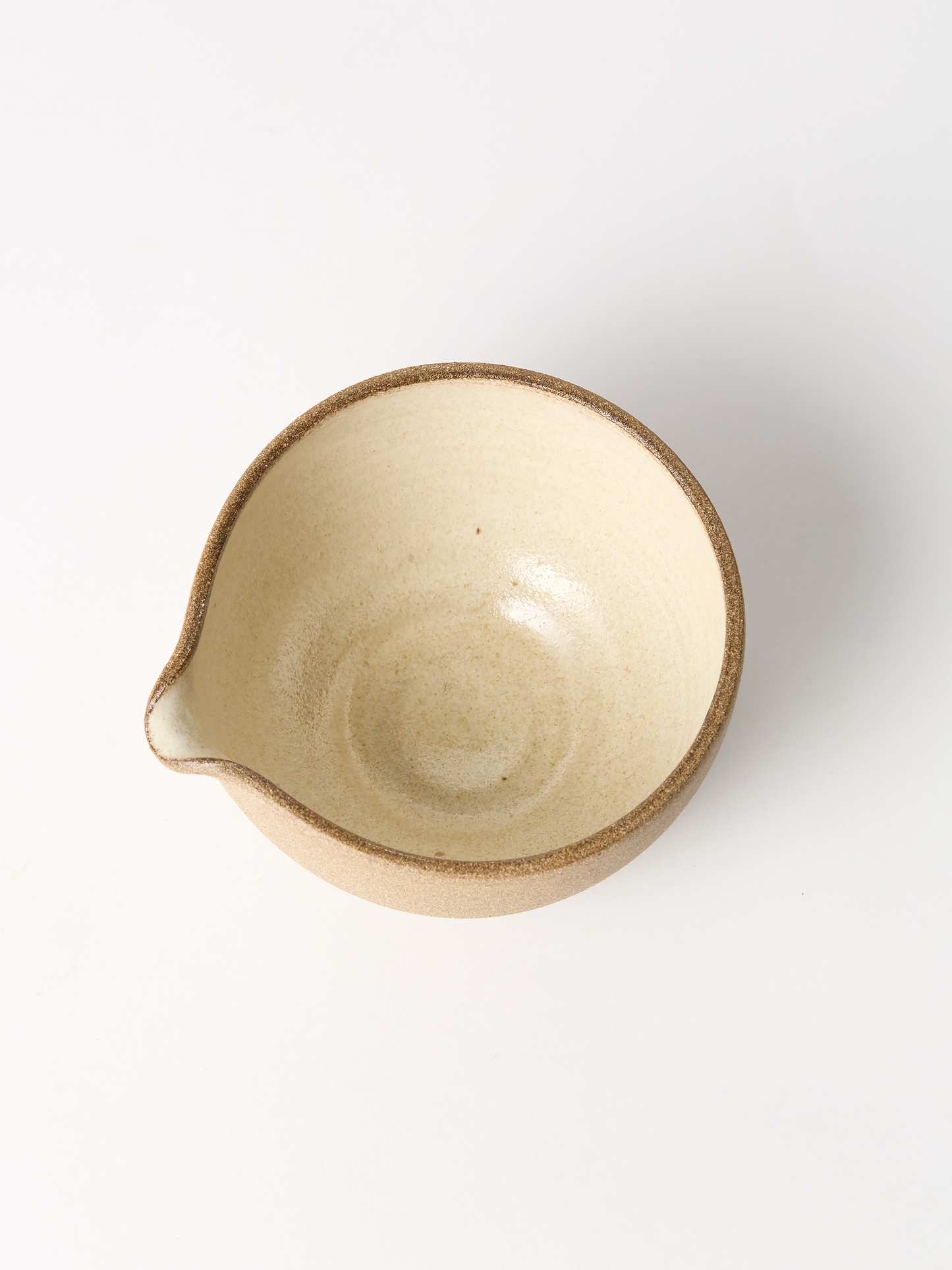 Beige ceramic bowl on a white background
