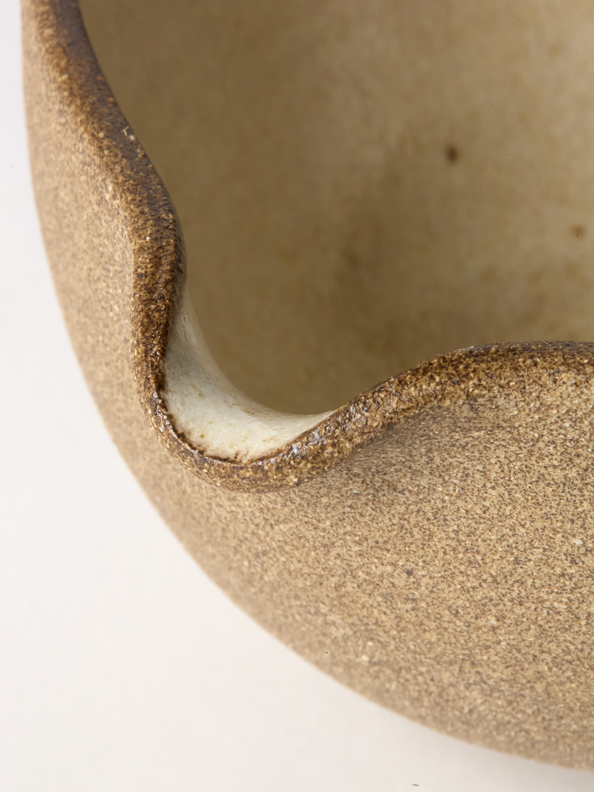 Close-up of a textured ceramic bowl on a white background