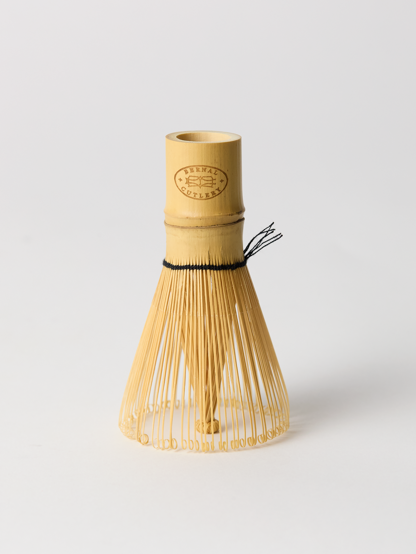Bamboo matcha whisk on a light gray background