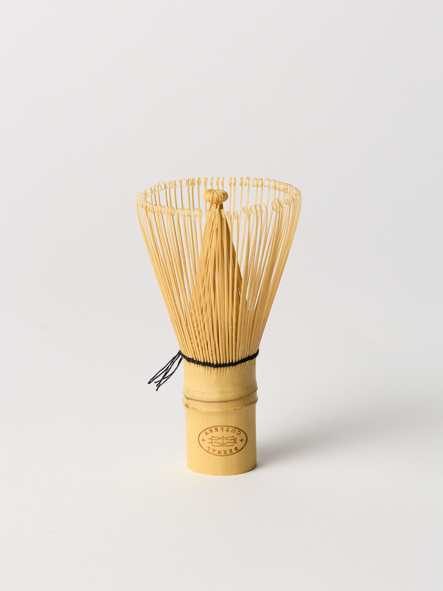Bamboo whisk for making matcha on a white background