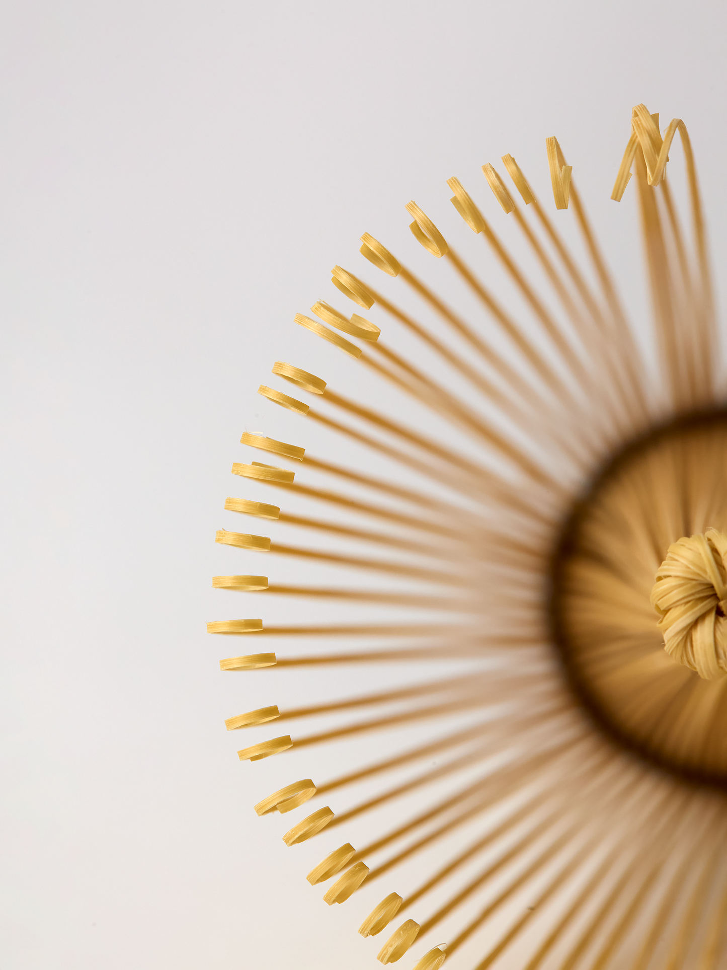 Artistic Close-up of a bamboo matcha whisk with a black band on a light background