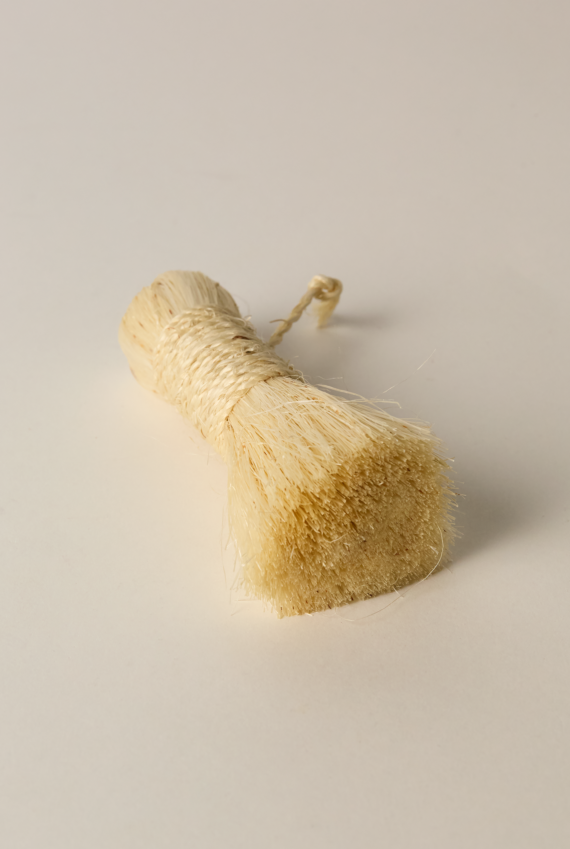 Small Handmade brush made from Tampico fiber light background