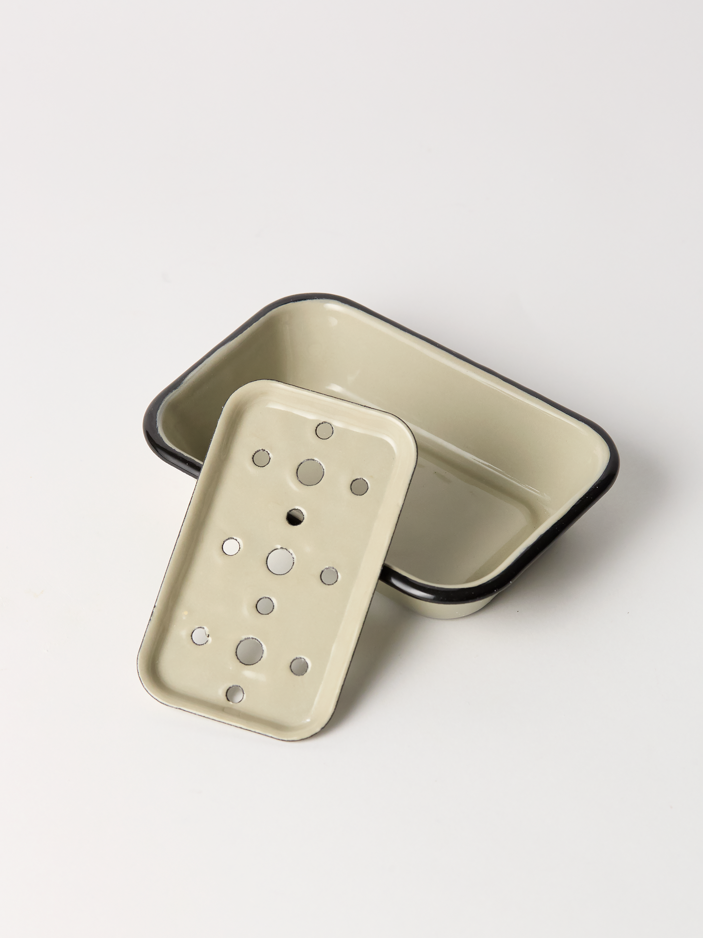 Beige enameled rectangular baking dish with a lid on a white background