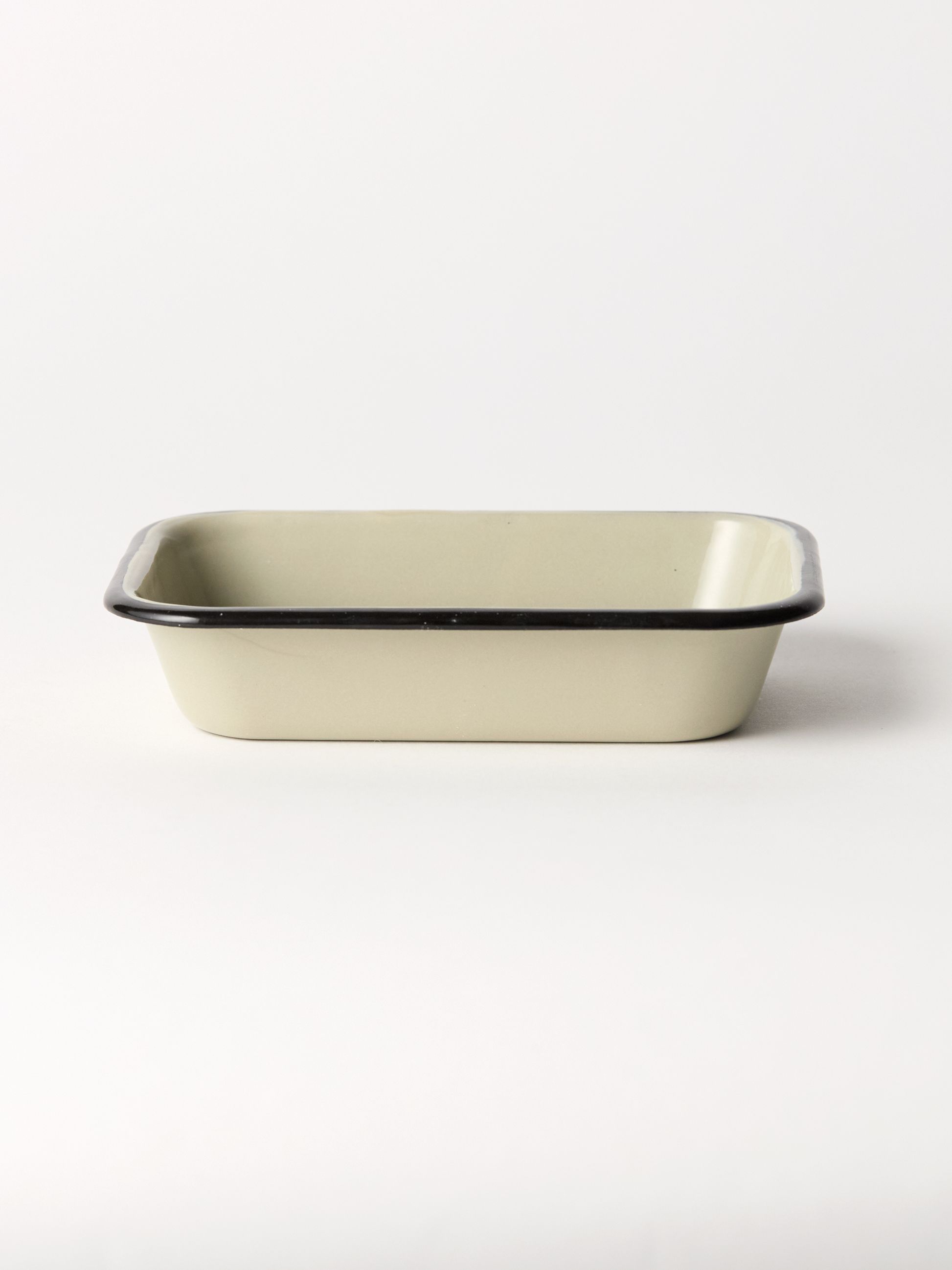Rectangular ceramic soap dish with black rim on a white background