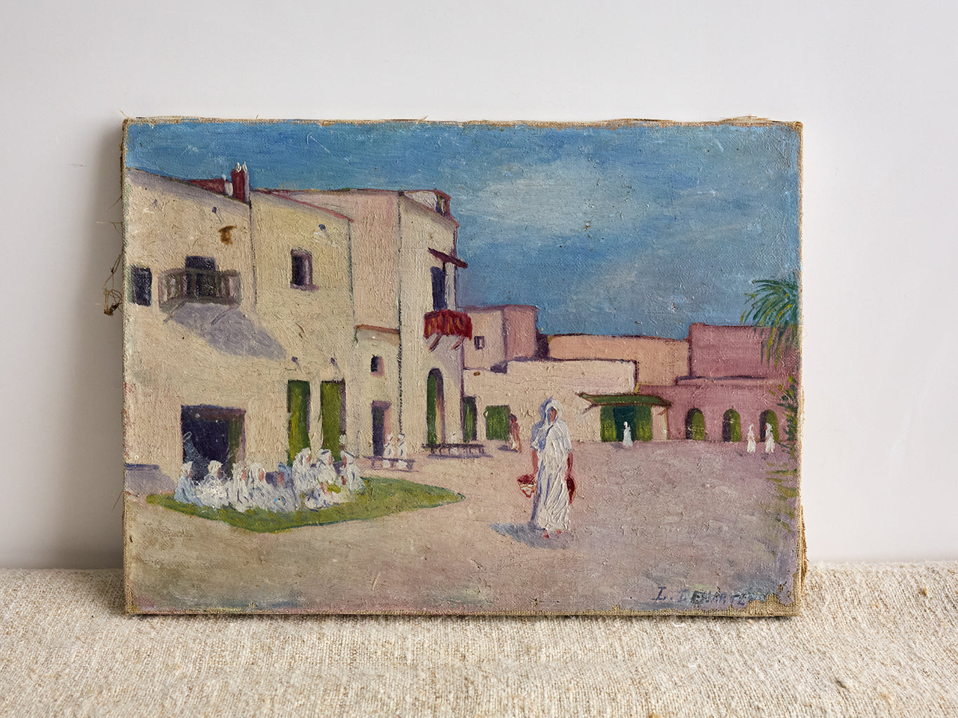 Vintage French Pink Houses Landscape Painting on white background with fabric underneath 