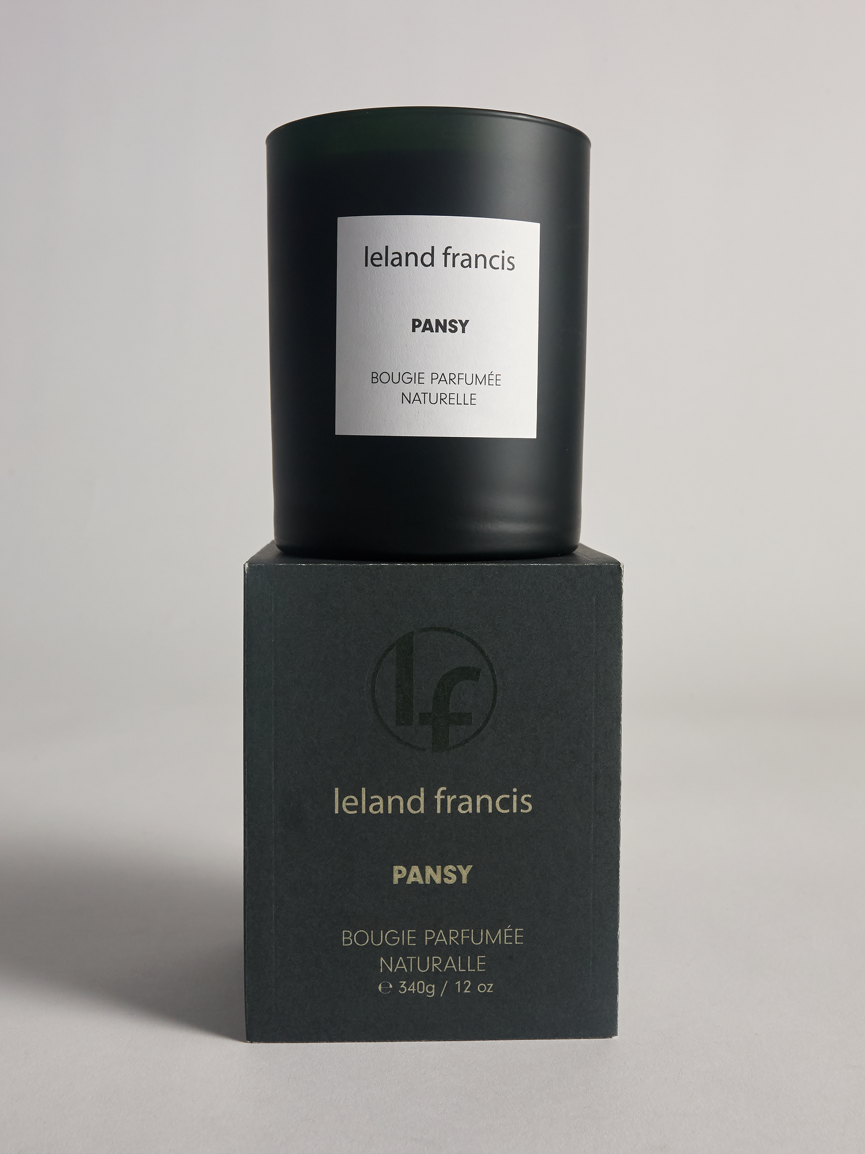 Ieland Francis Pansy candle and packaging on a gray background