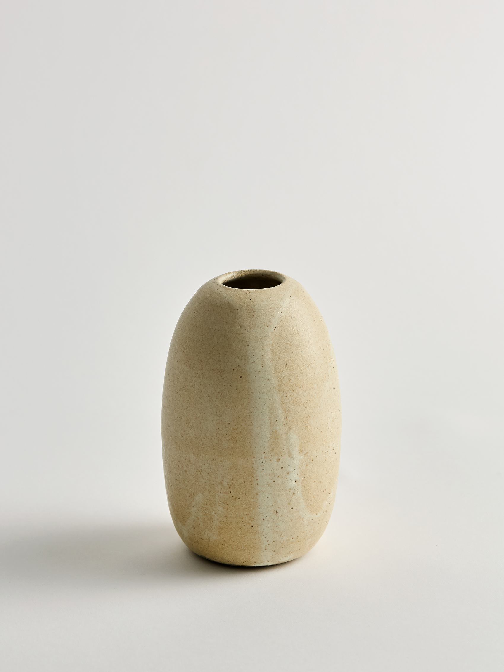 Taller Beige ceramic vase on a light gray background