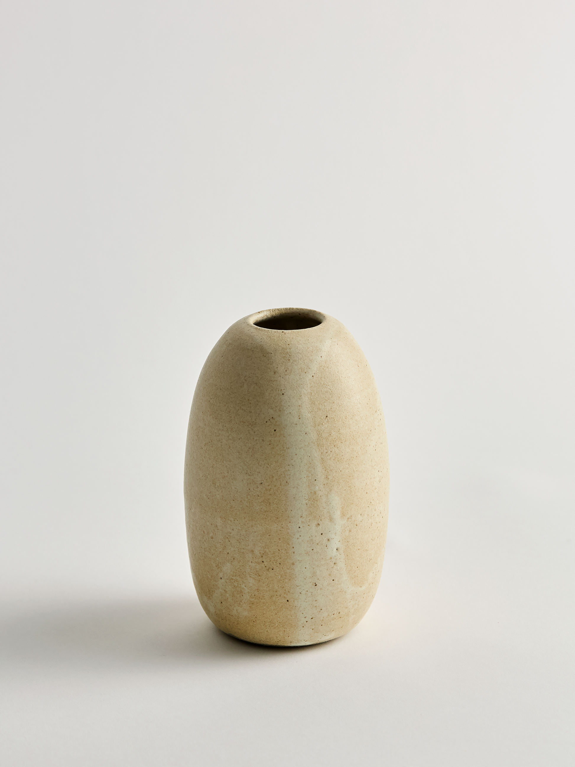 Taller Beige ceramic vase on a light gray background