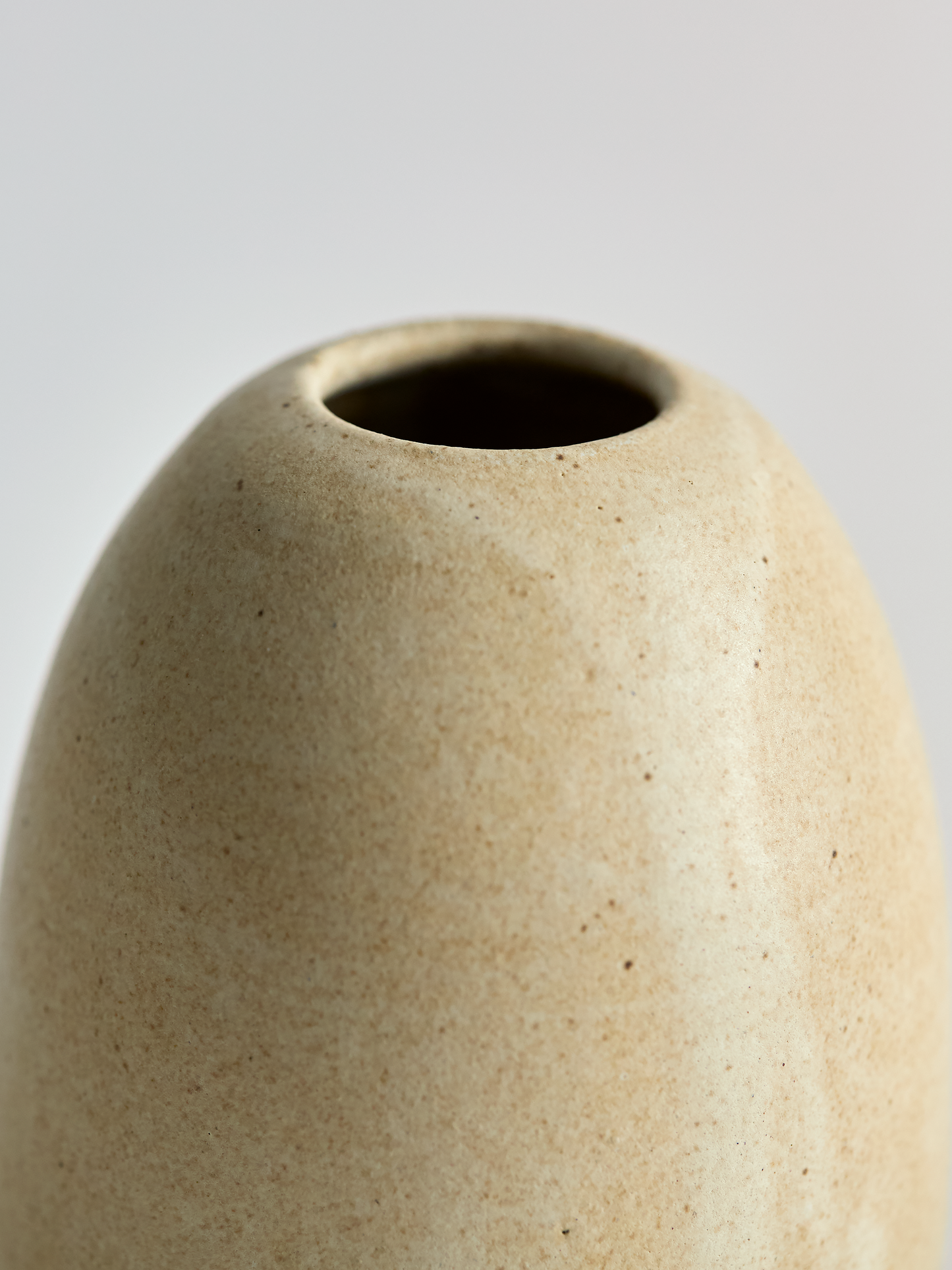 Lorie Stout Pottery close up beige ceramic vase on a light gray background