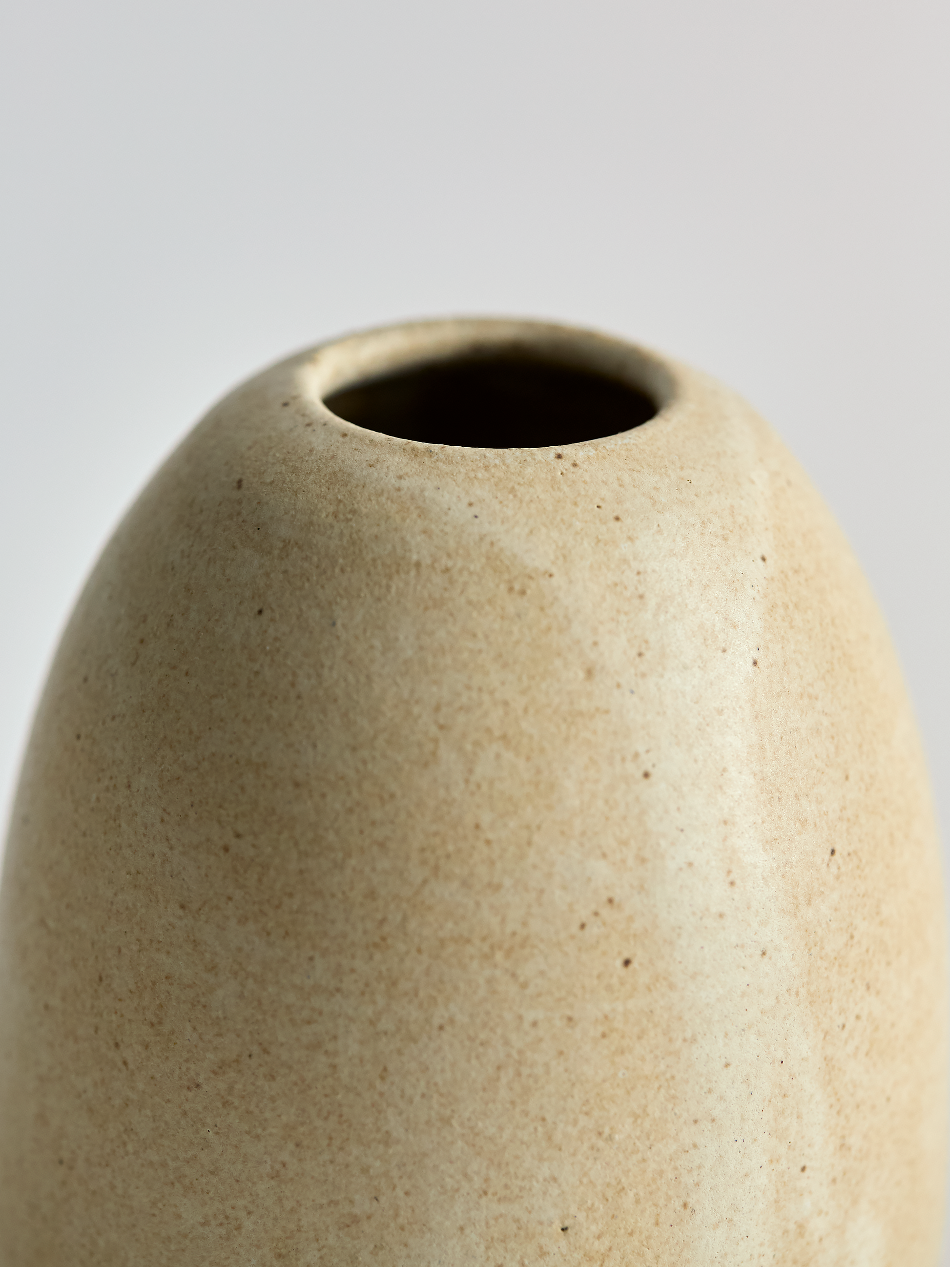 Lorie Stout Pottery close up beige ceramic vase on a light gray background
