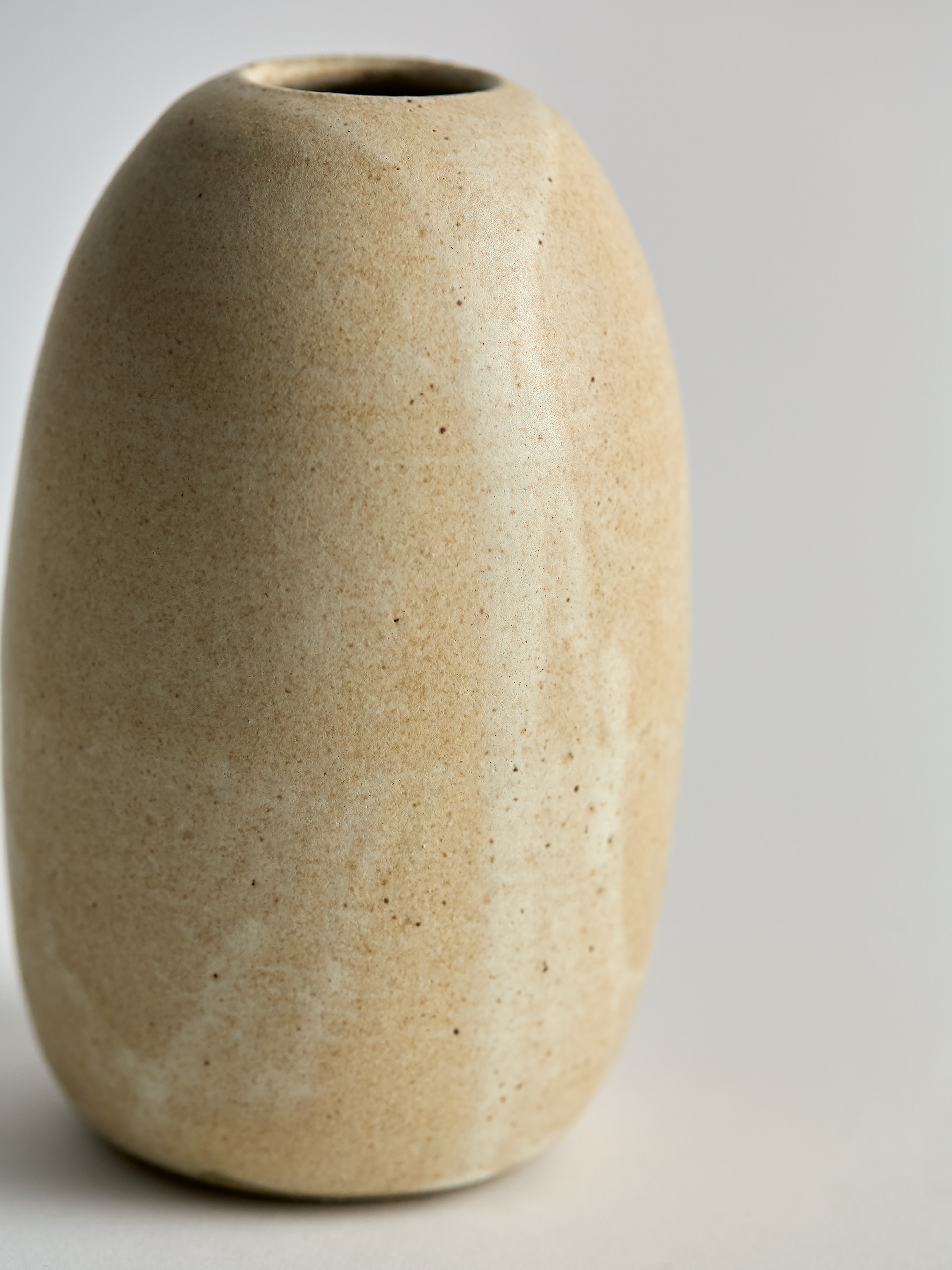 Lorie Stout Pottery off angle left beige ceramic vase on a light gray background
