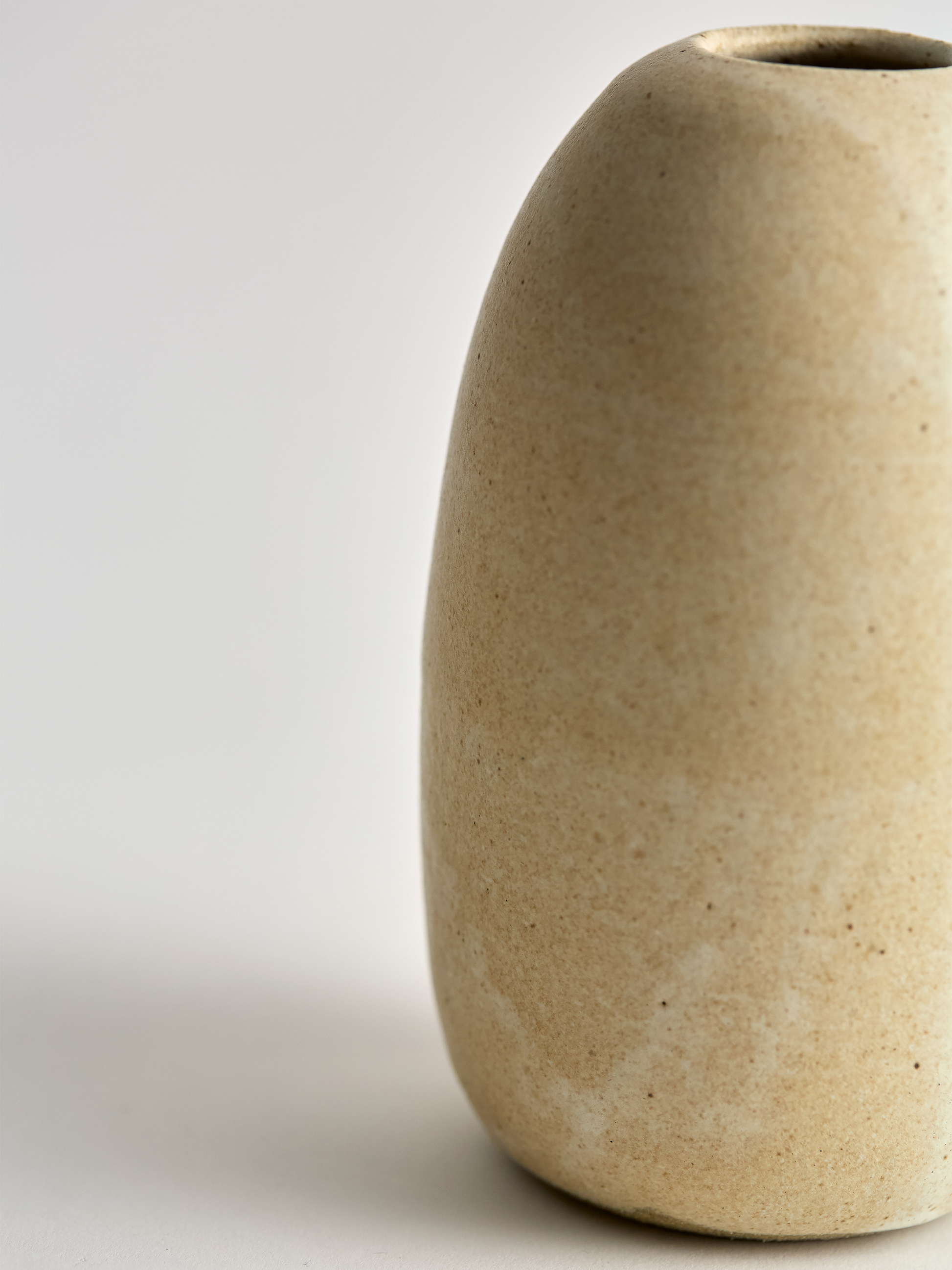Lorie Stout Pottery off angle right beige ceramic vase on a light gray background