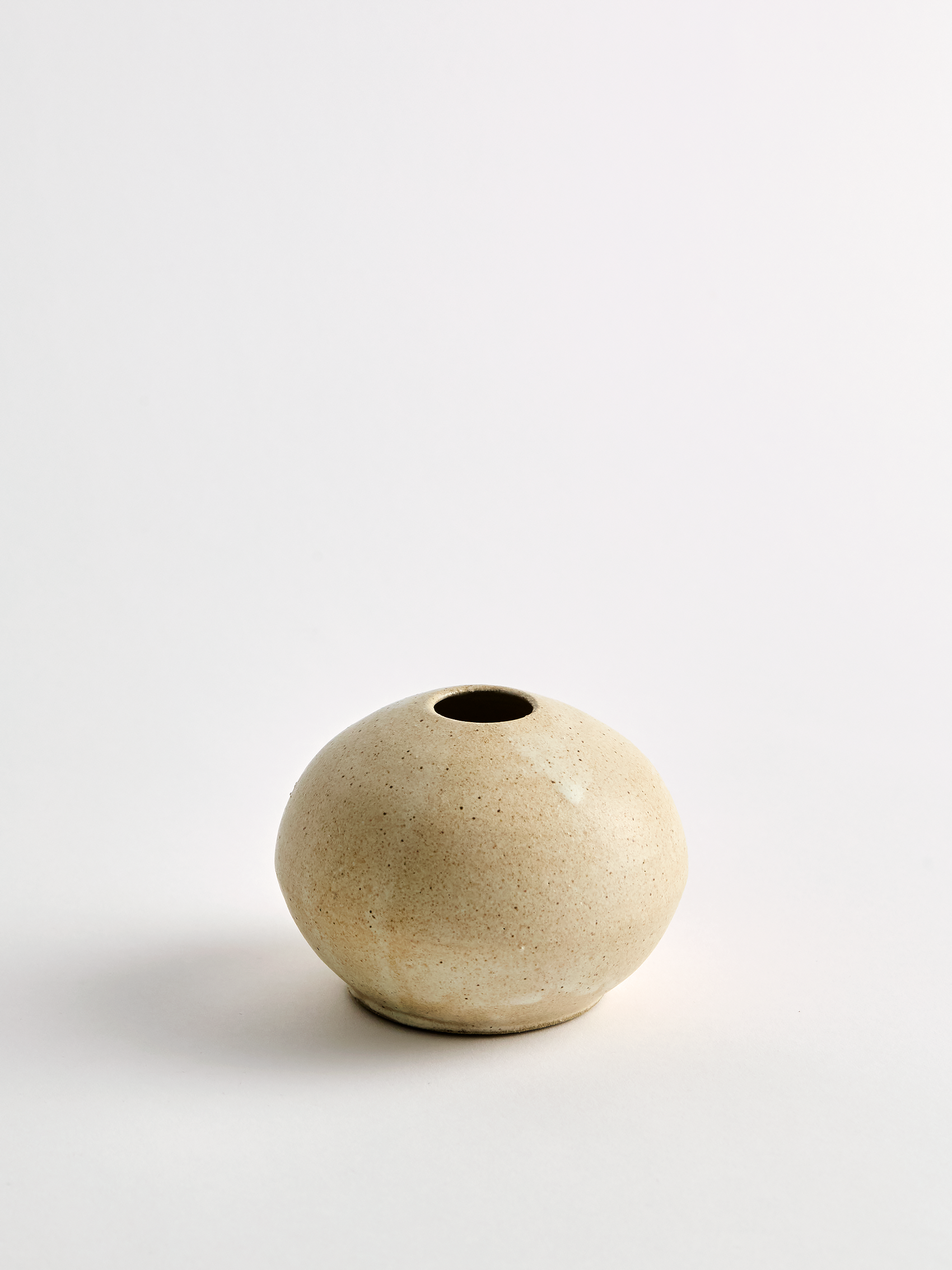 Lorie Stout Small beige ceramic bud vase on a light gray background