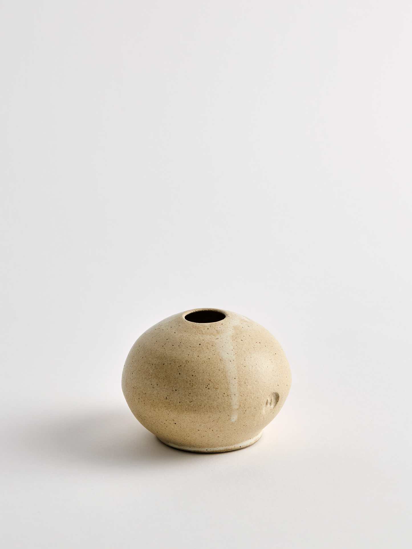 Lorie Stout Small beige ceramic bud vase on a light gray background alt angle