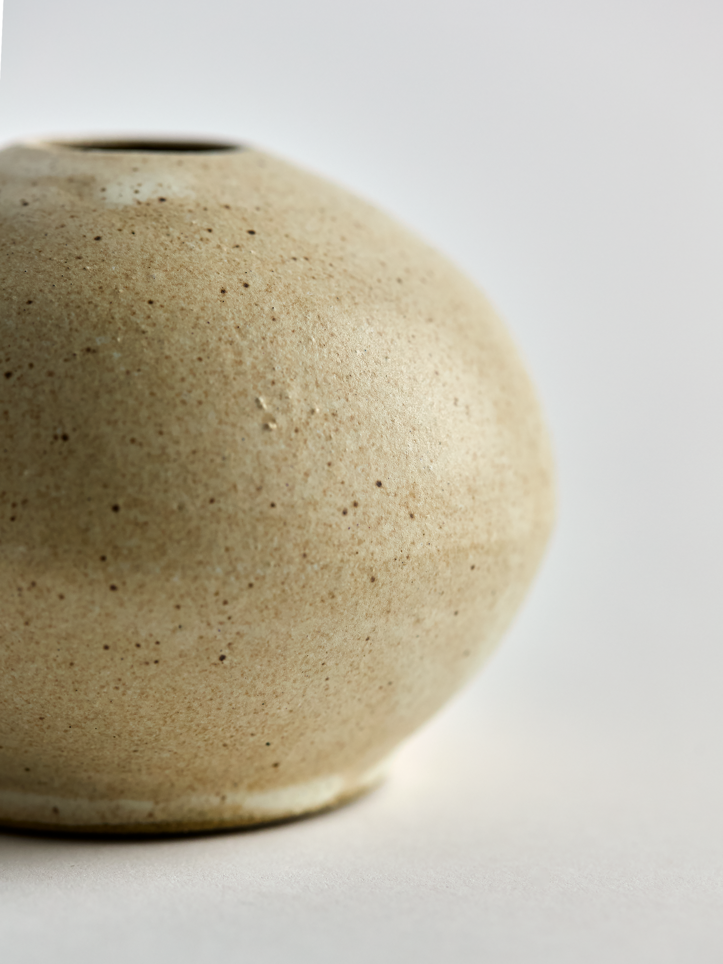 Close-up of a textured ceramic vase on a light background