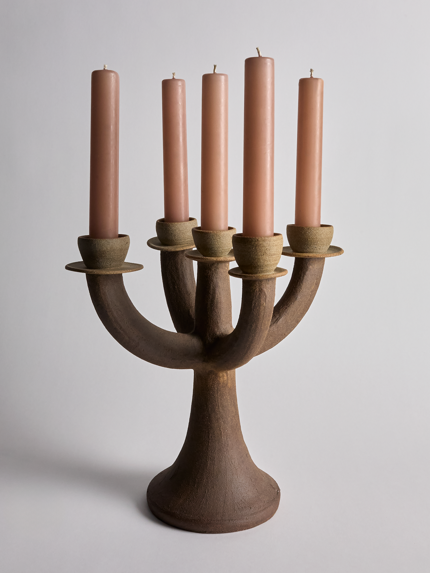 Martha Day ceramic candelabra with five pink candles on a light gray background full image 1.