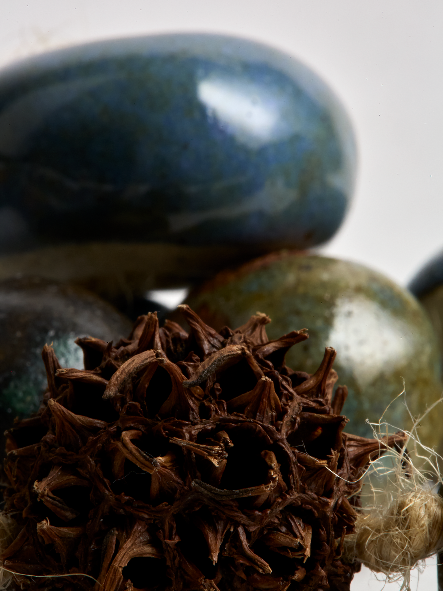 Close-up Ceramic Garland, hand crafted Blue glazed  beads and seed pod