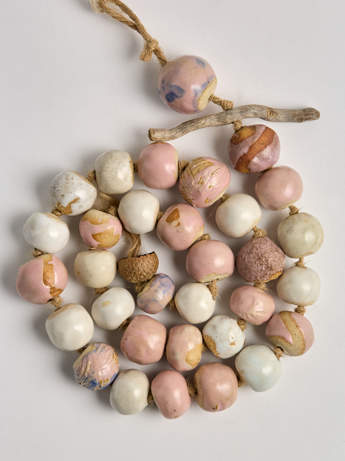 Pink & Cream Ceramic Garland handcrafted beads coiled on a rope with twig