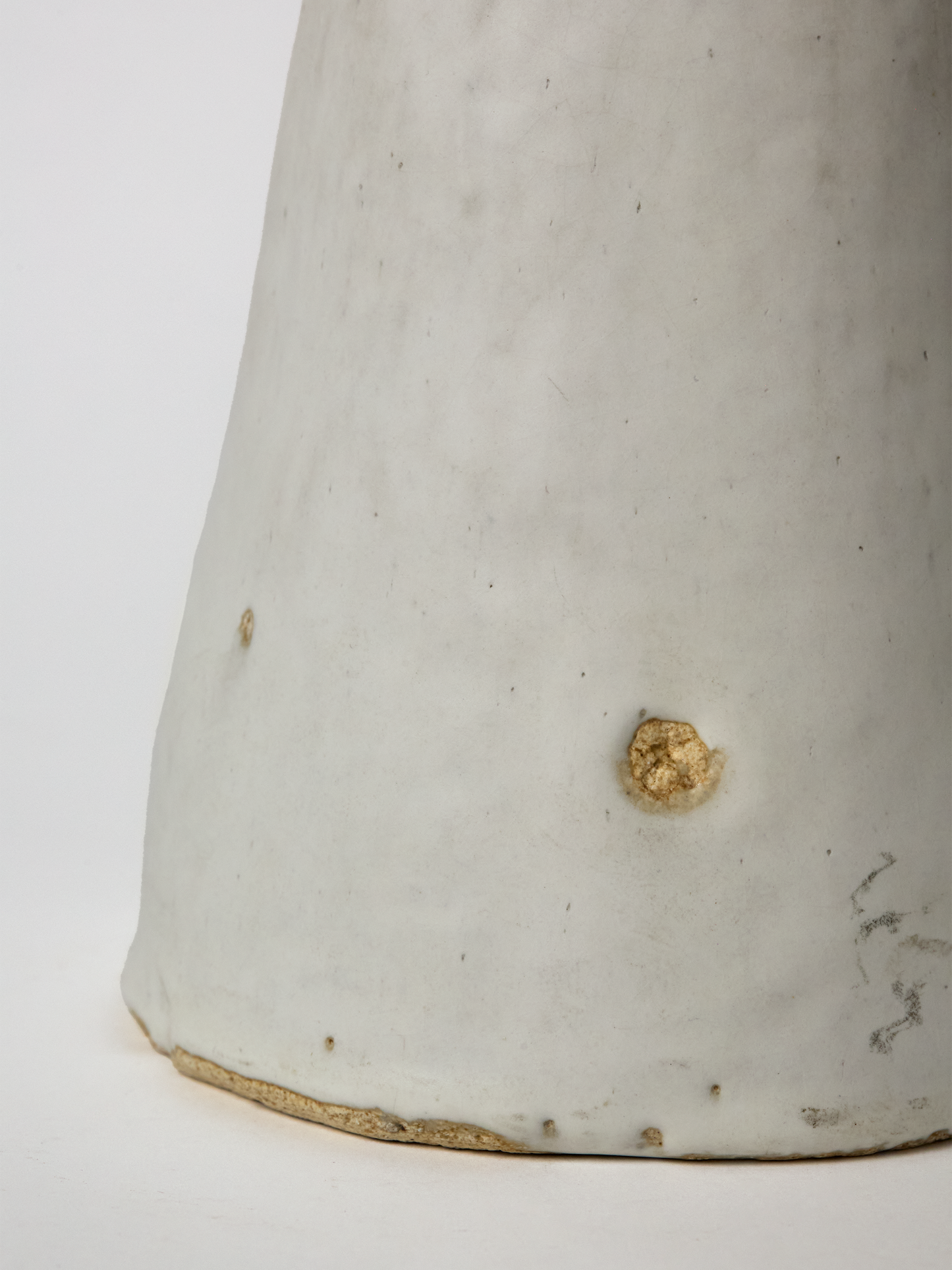 Close-up of the base of a Large  Pascale Vaquette ceramic matte glaze Cloud  Sculpture on a white background.