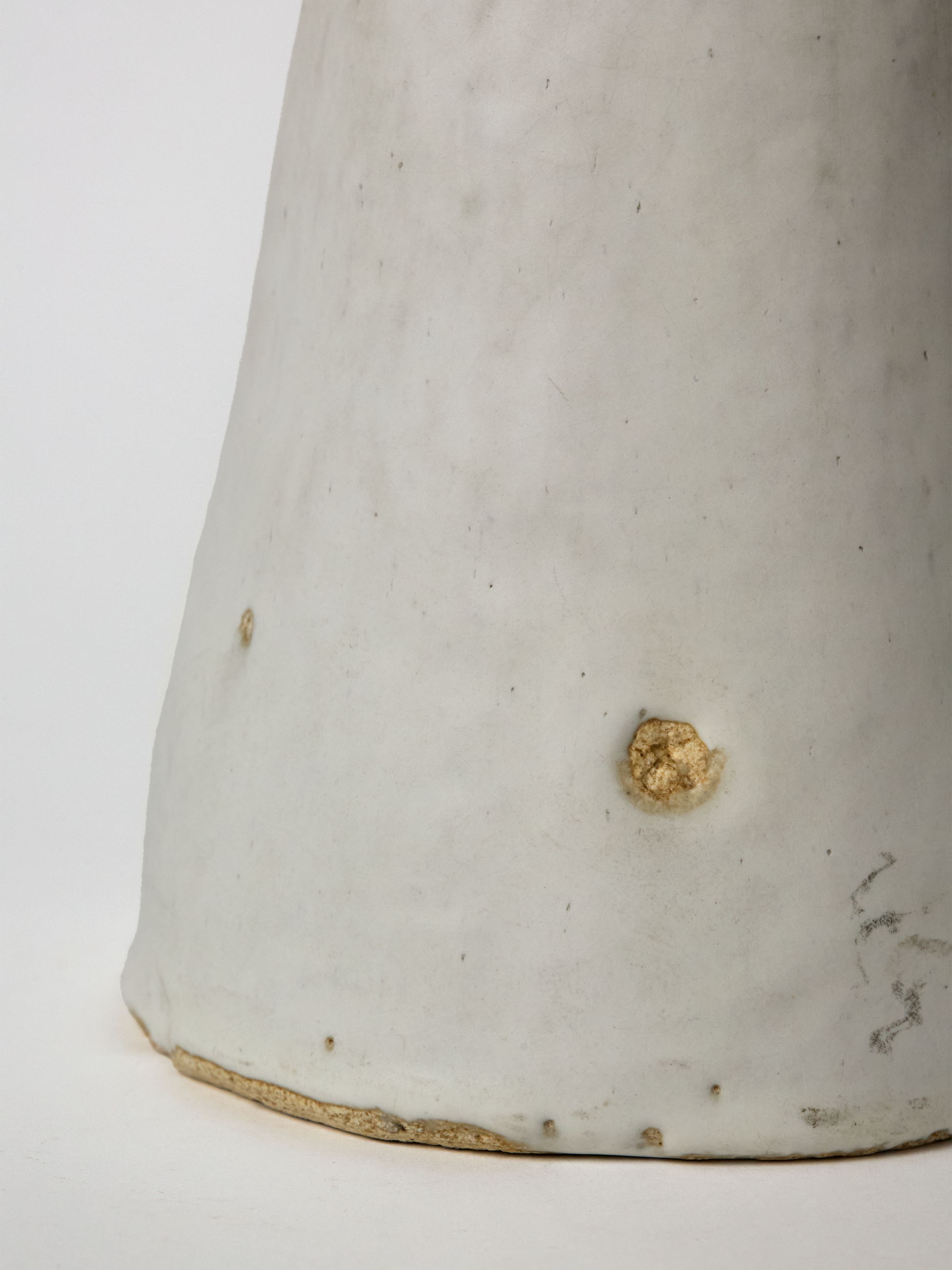Close-up of the base of a Large  Pascale Vaquette ceramic matte glaze Cloud  Sculpture on a white background.