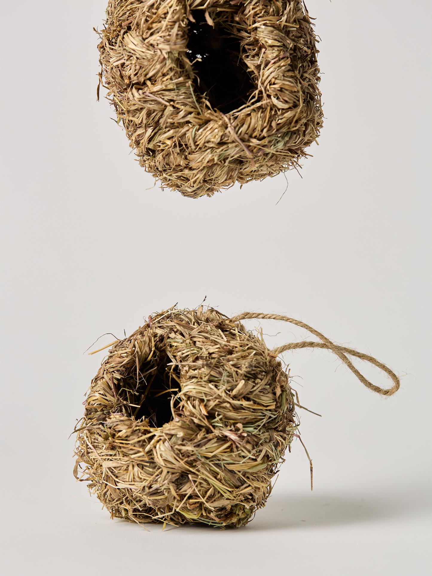 Hanging Hummingbird House made from natural grass showing two angels both open circle and square openings