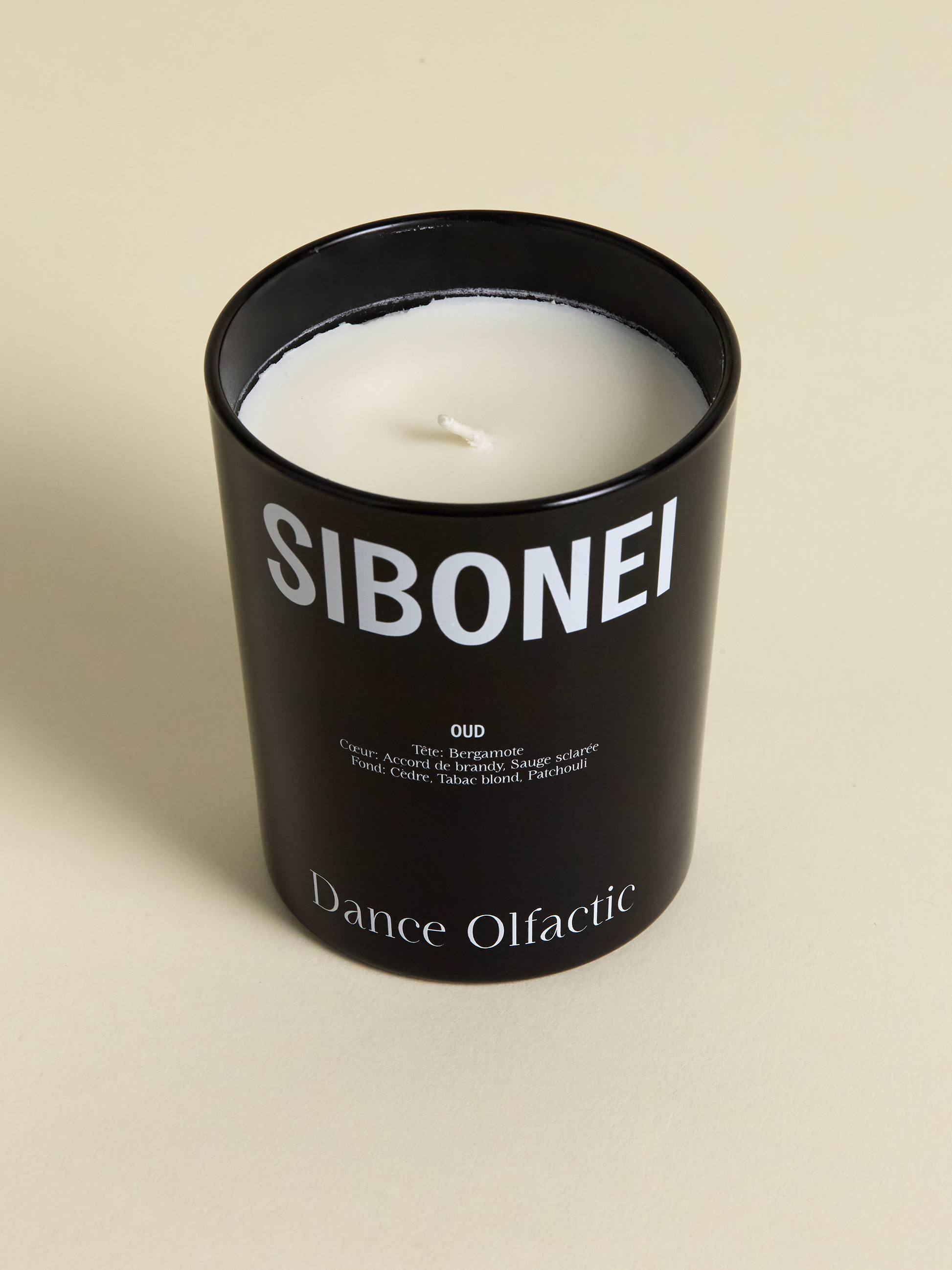 Sibonei Oud "Dance Olfactic" candle on light background