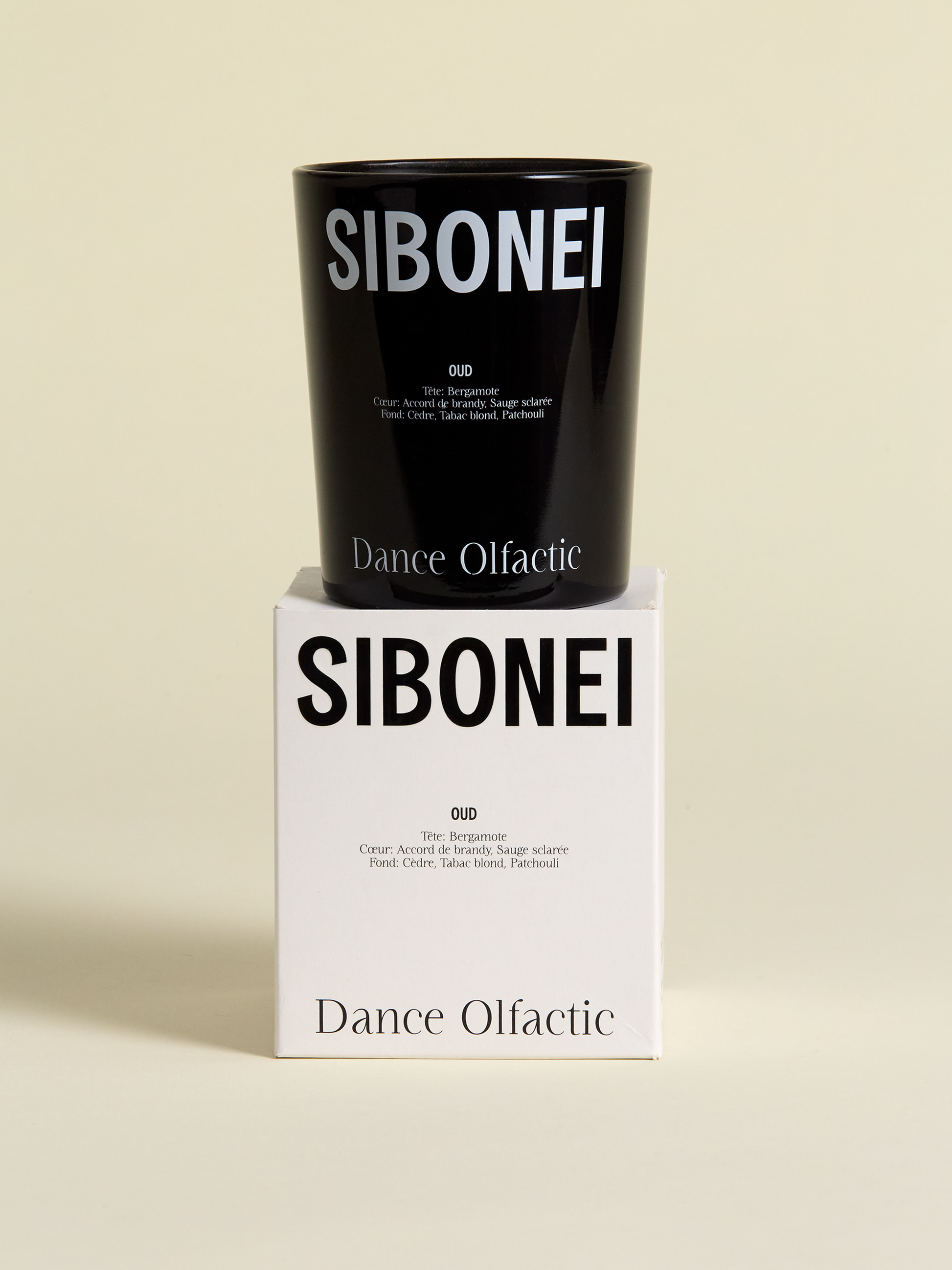 Sibonei candle on top of candle box, oud, dance olfactic