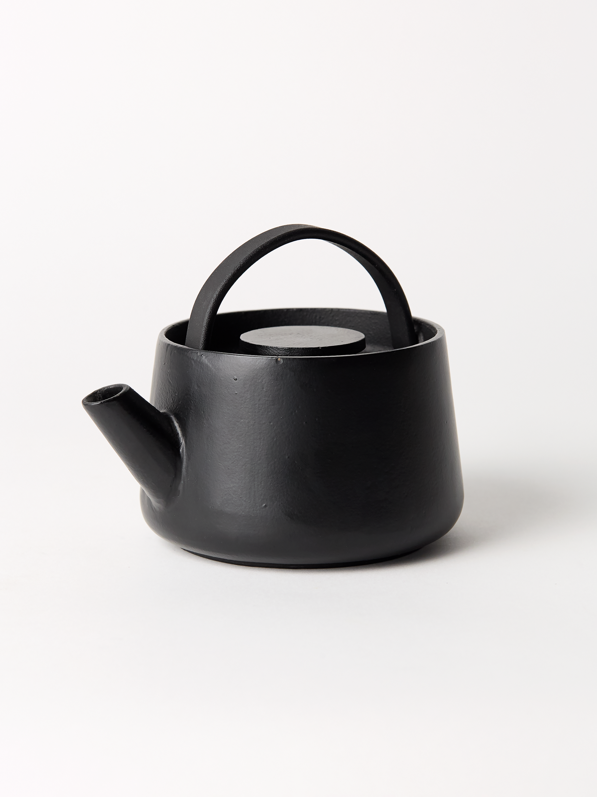 Black ceramic teapot on a white background
