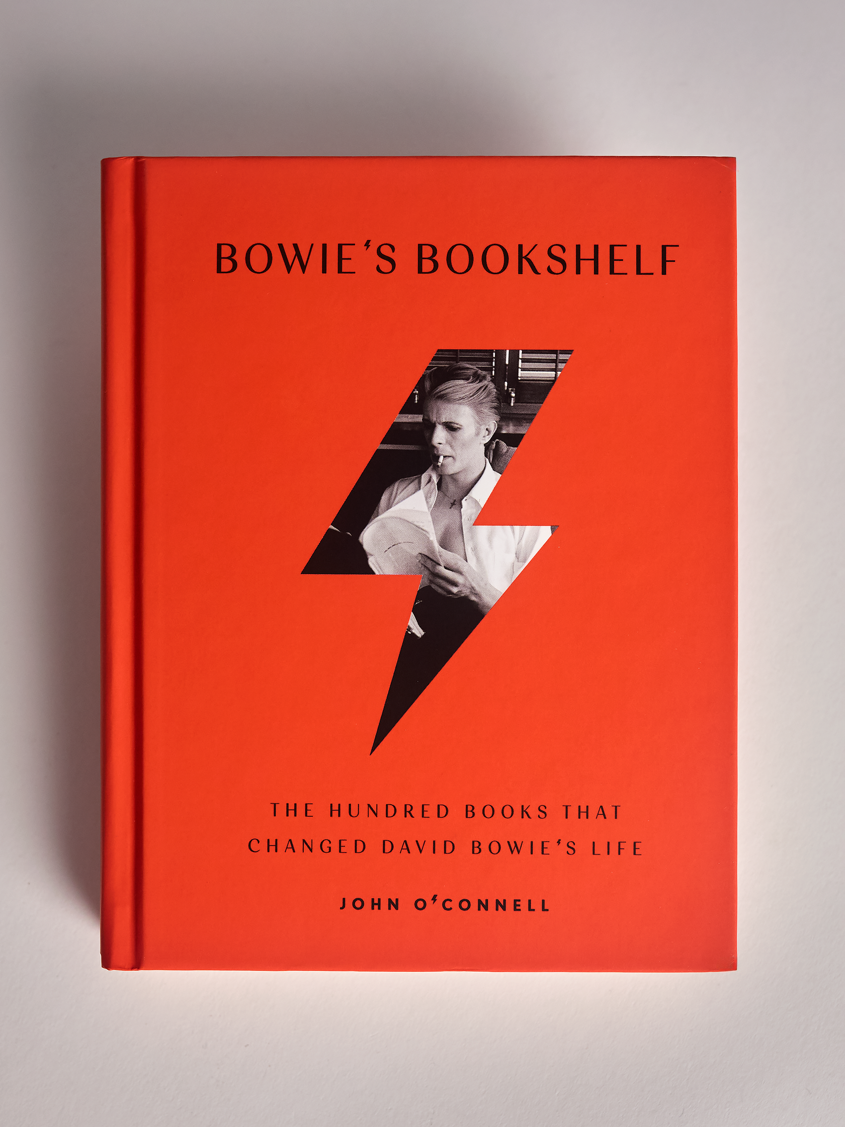 Orange Bowie's Bookshelf hard cover book front cover on grey background