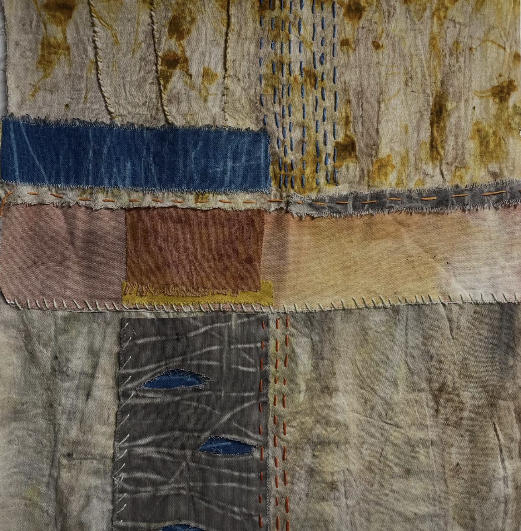 Kathy Leader Textile art piece with patchwork pattern in earthy tones